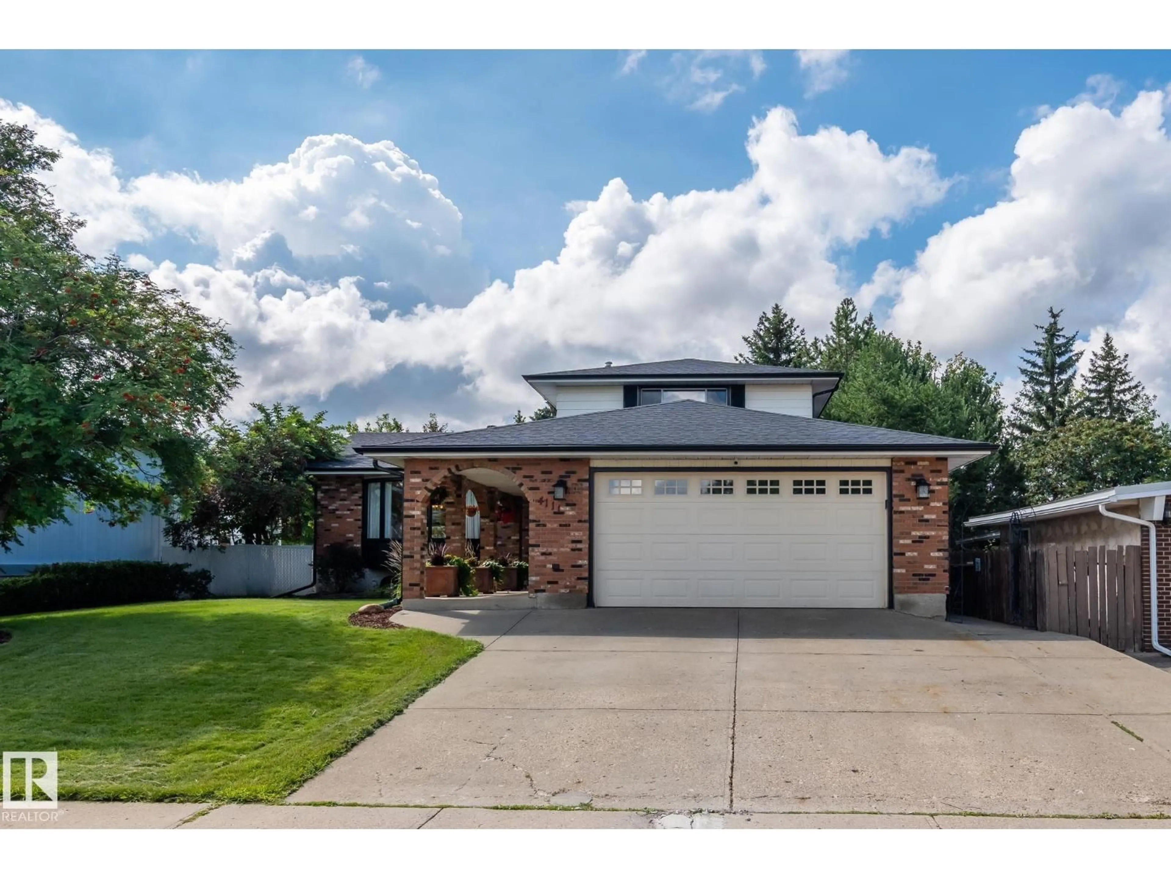 Home with brick exterior material, street for NW - 4111 131 AV, Edmonton Alberta T5A2S6