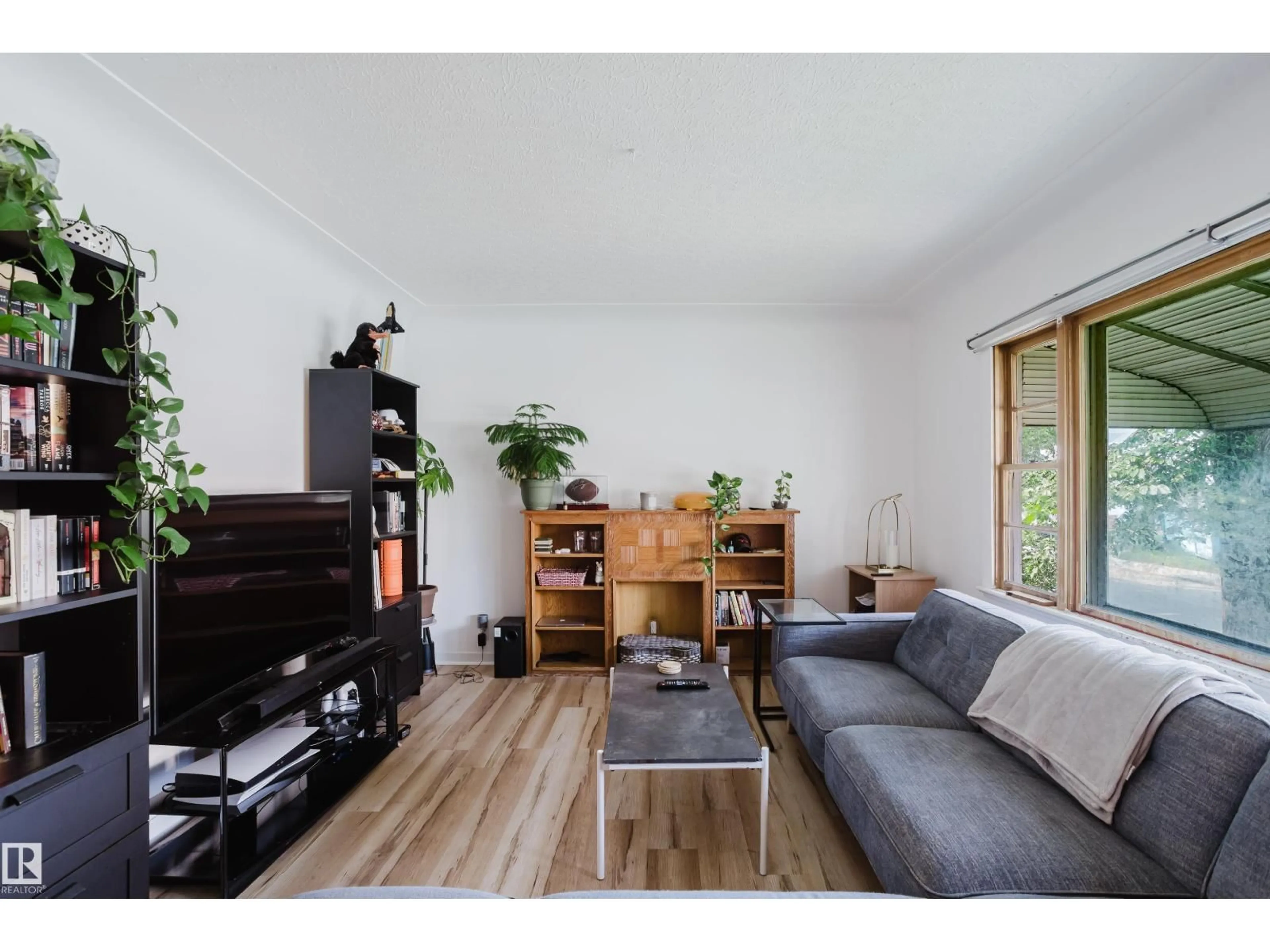 Living room with furniture, wood/laminate floor for NW - 8759 78 AV, Edmonton Alberta T6C0N5