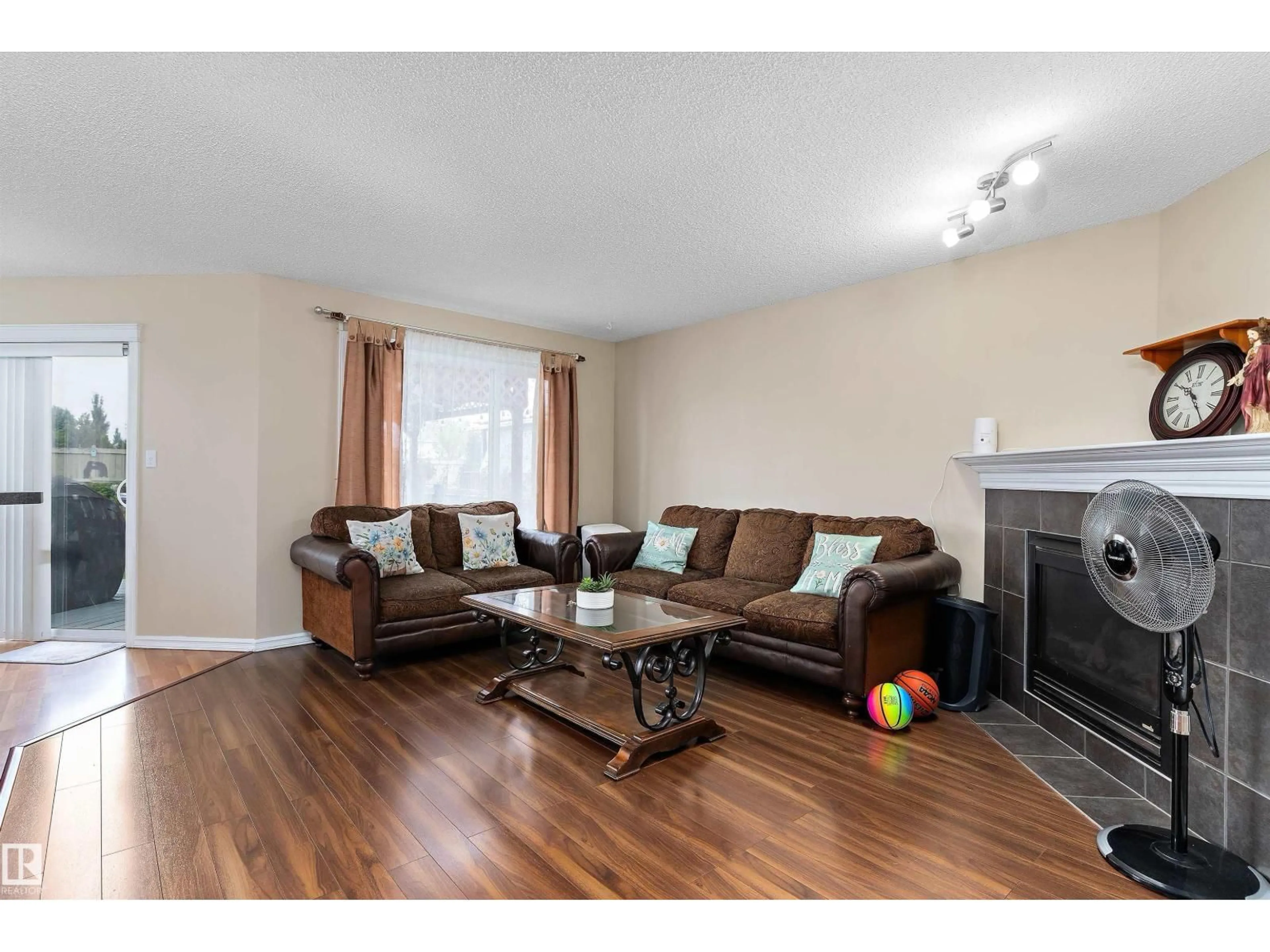 Living room with furniture, wood/laminate floor for SW - 8521 8 AV, Edmonton Alberta T6X1G6
