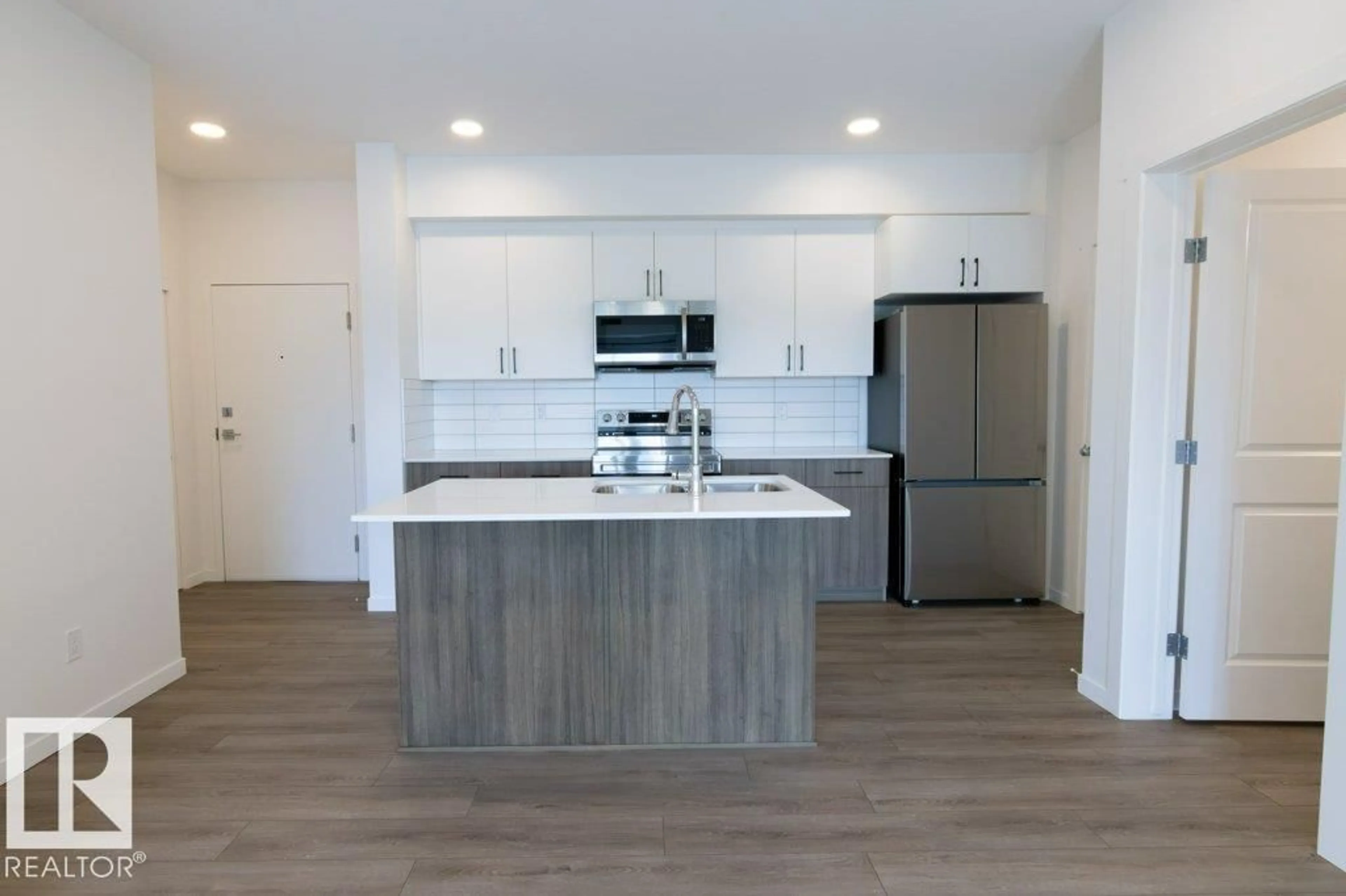 Open concept kitchen, wood/laminate floor for 206 - 9211 228 ST, Edmonton Alberta T5T4T1