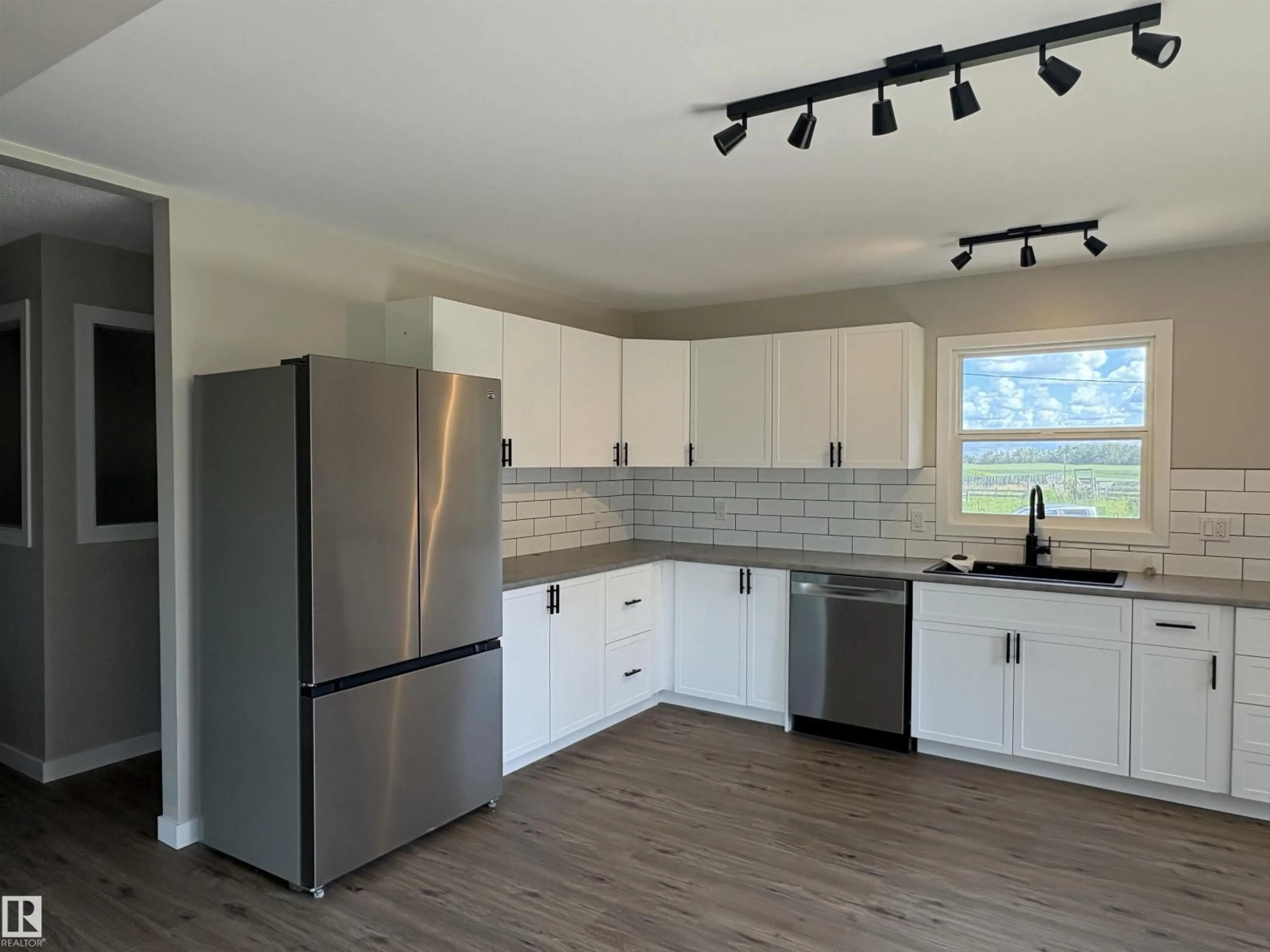 Open concept kitchen, wood/laminate floor for 602 EAST OF HWY 827, Rural Thorhild County Alberta T0A3J0