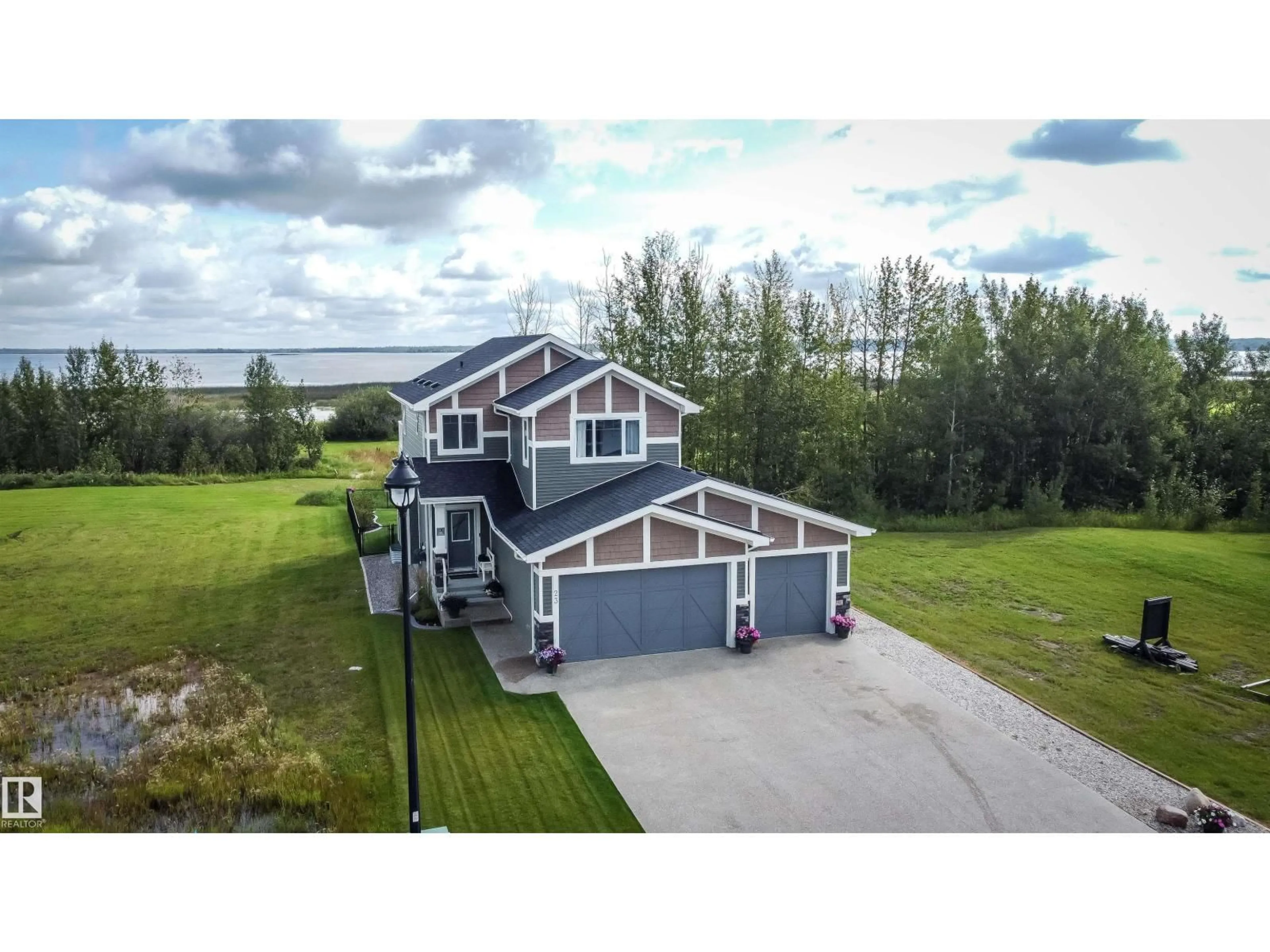 A pic from outside/outdoor area/front of a property/back of a property/a pic from drone, water/lake/river/ocean view for 3410 STE. ANNE TR, Rural Lac Ste. Anne County Alberta T0E0A1