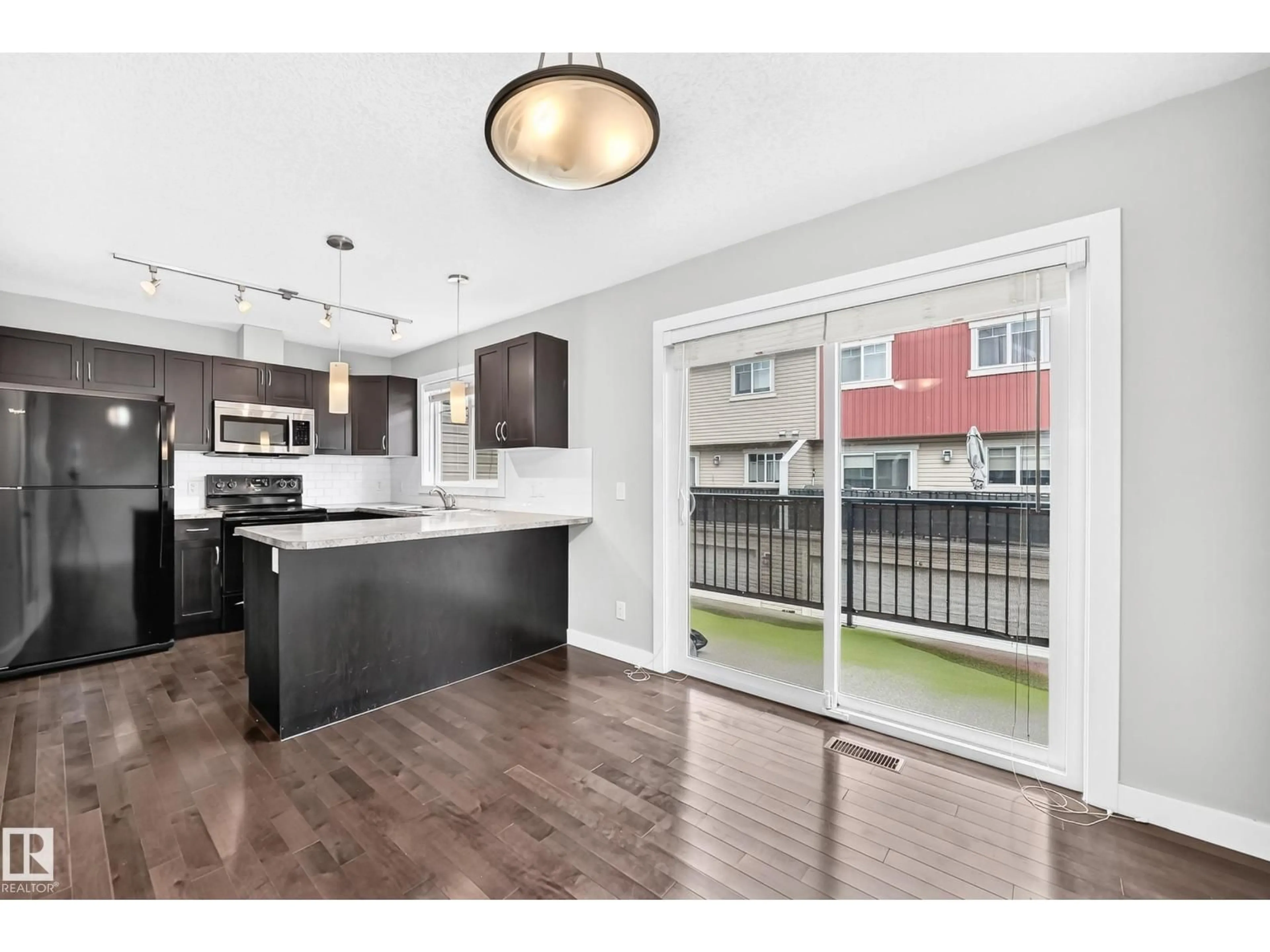 Open concept kitchen, wood/laminate floor for 73 9535 217 ST NW, Edmonton Alberta T5T4P5