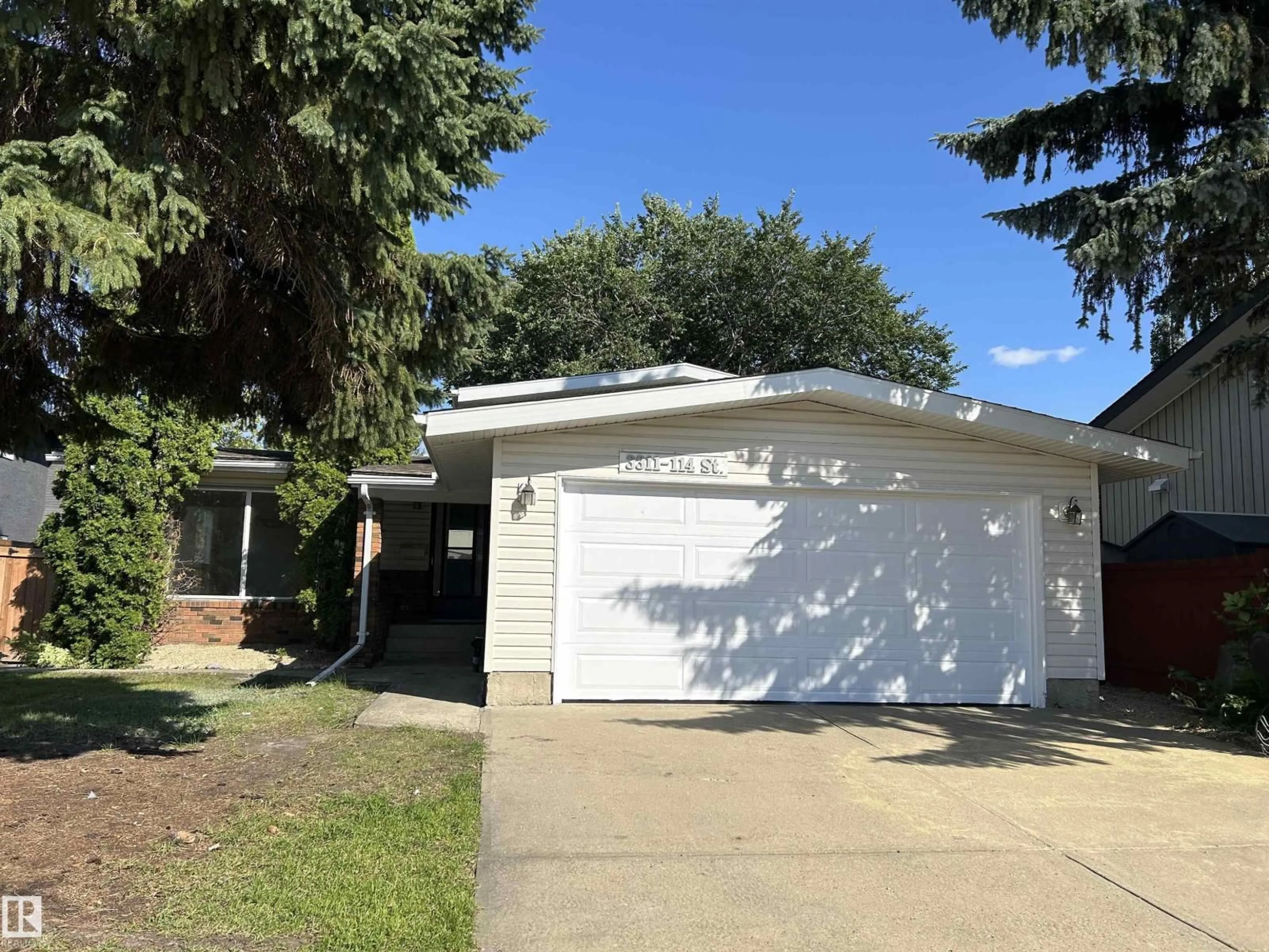 Home with vinyl exterior material, street for 3311 114 ST, Edmonton Alberta T6J4B1