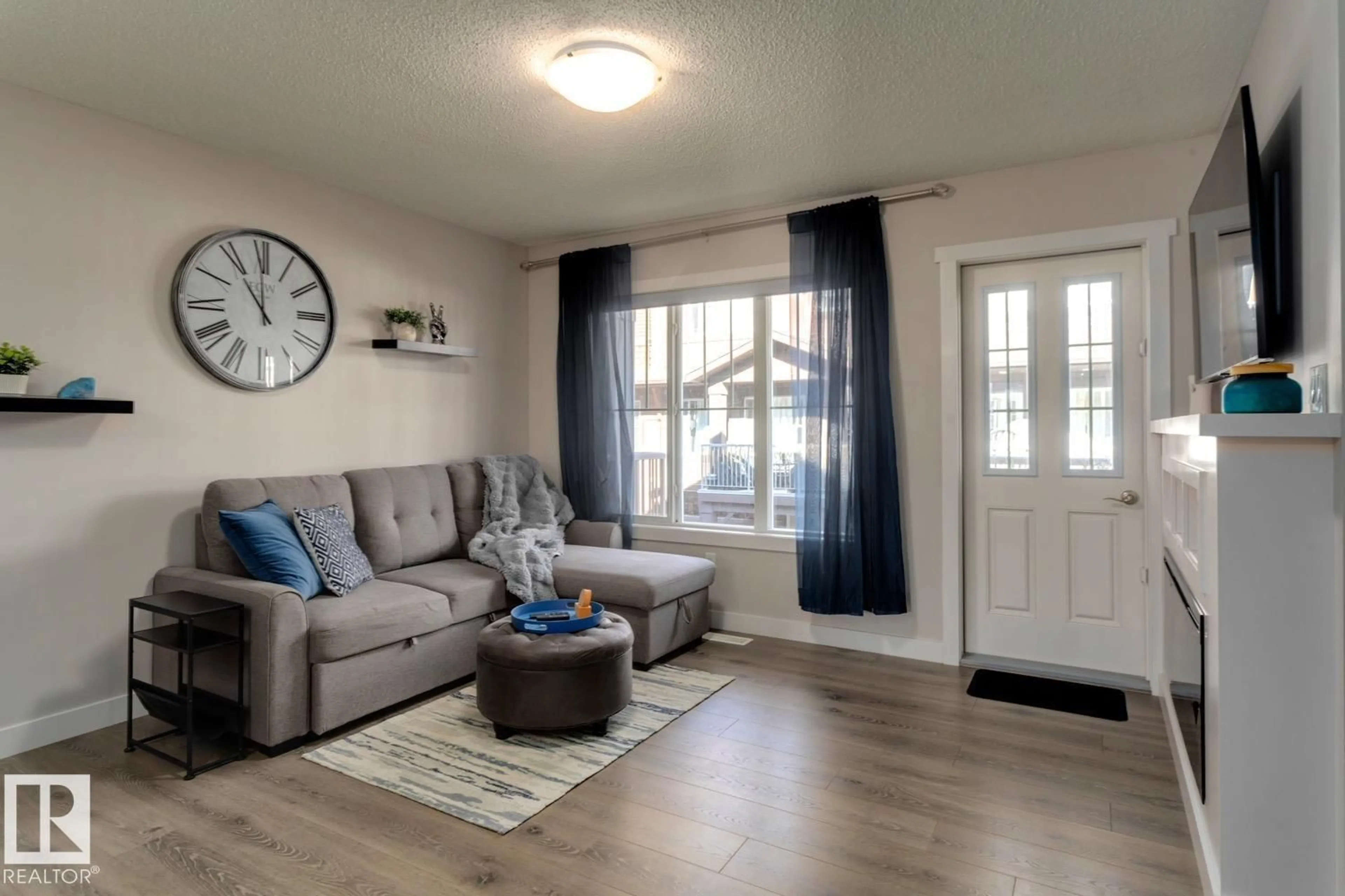 Living room with furniture, wood/laminate floor for 72 - 1005 GRAYDON HILL BV, Edmonton Alberta T6W3J5