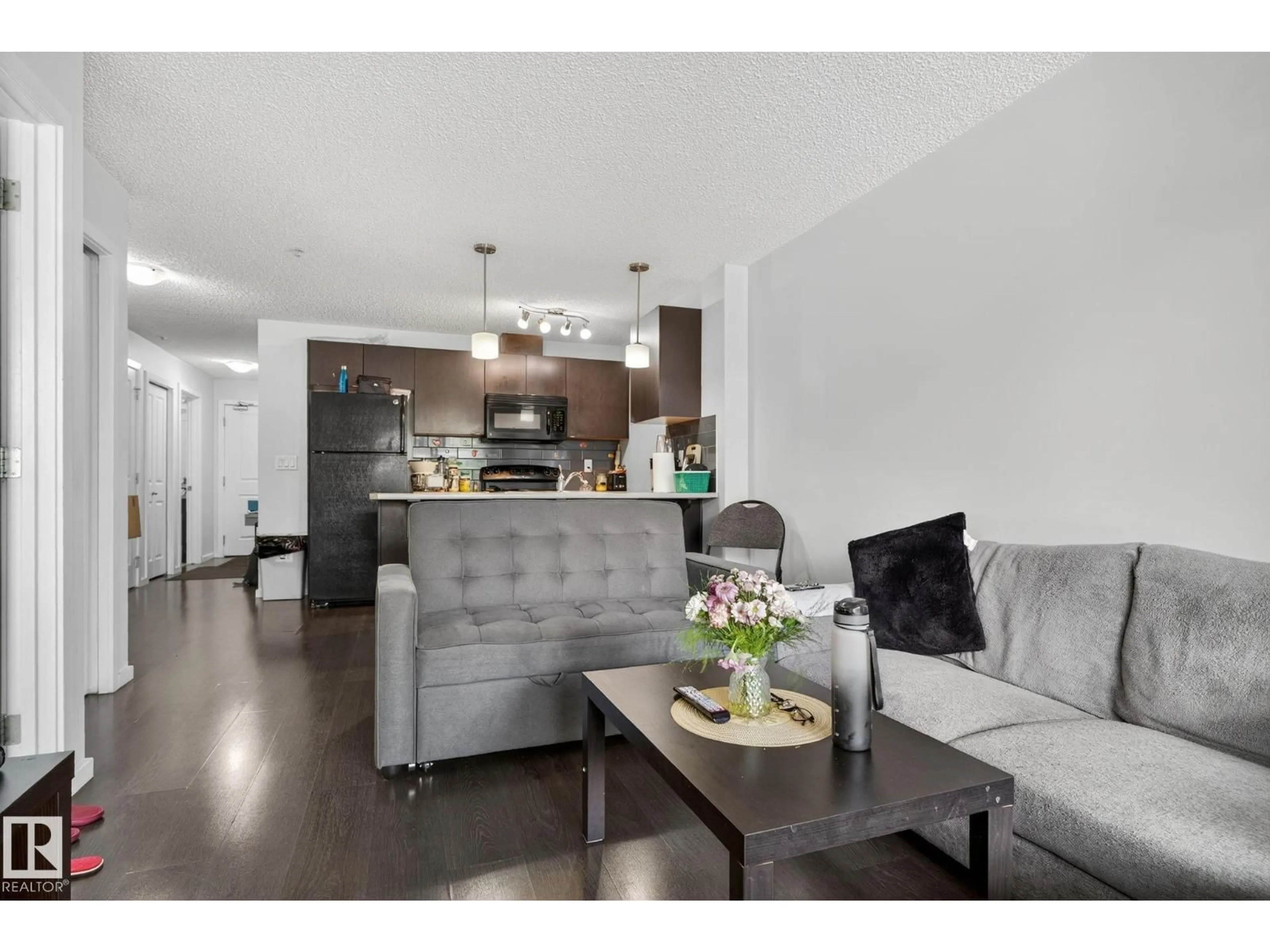 Living room with furniture, wood/laminate floor for 3353 16A AV, Edmonton Alberta T6T0V4