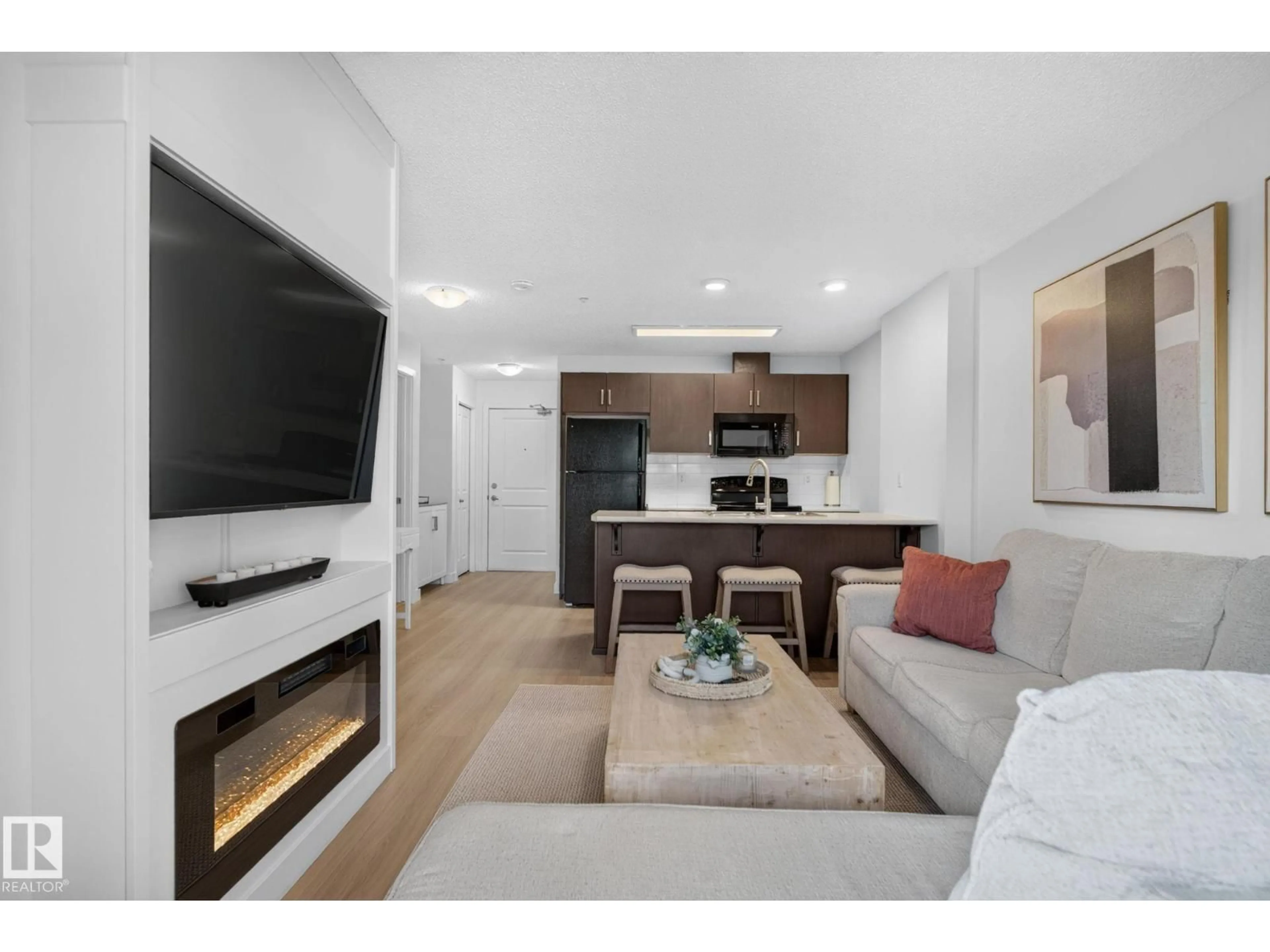 Living room with furniture, wood/laminate floor for #203 - 5521 7 AV, Edmonton Alberta T6X2A8