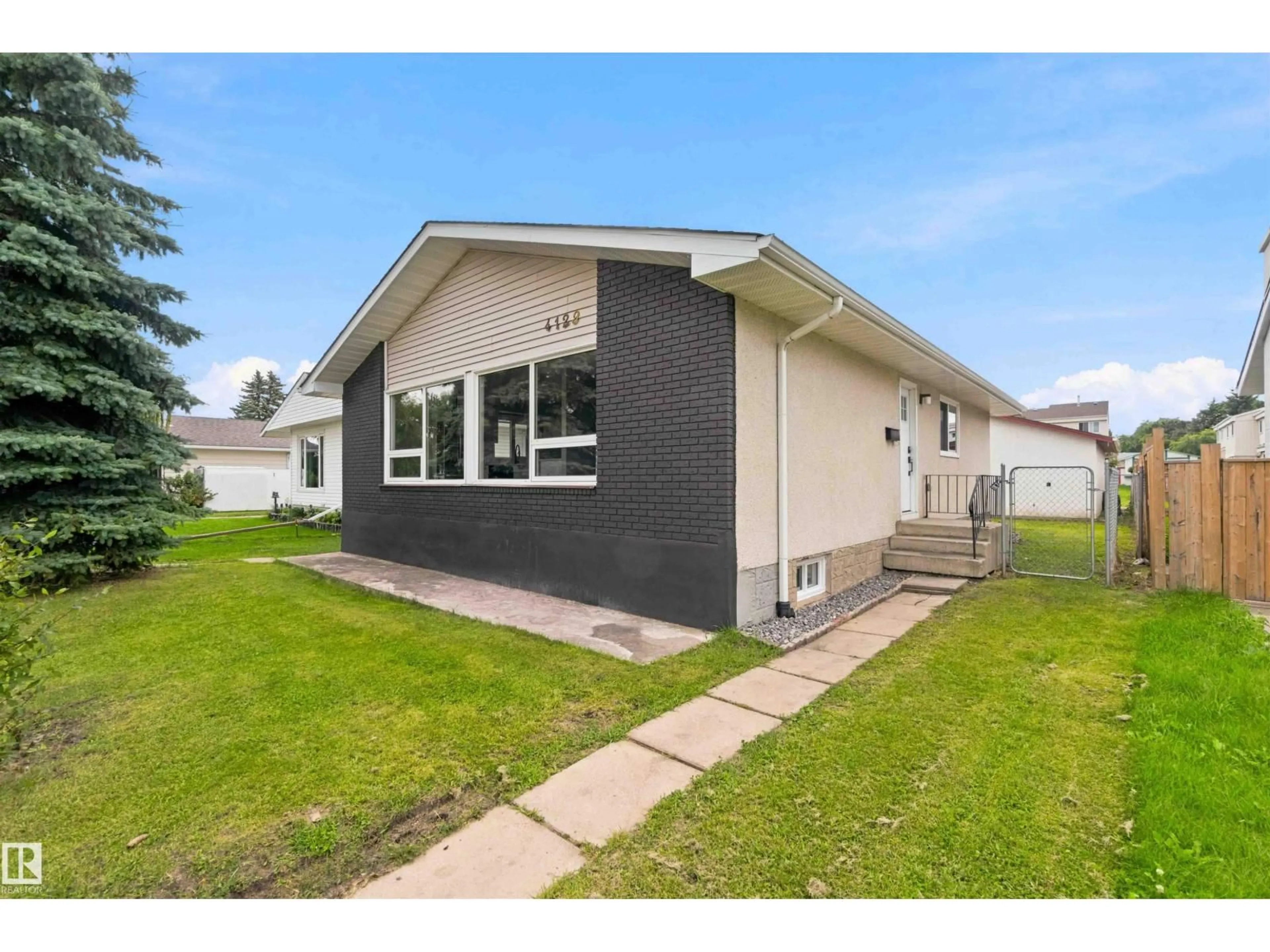 Home with vinyl exterior material, street for 4129 134A AV, Edmonton Alberta T5A2N2