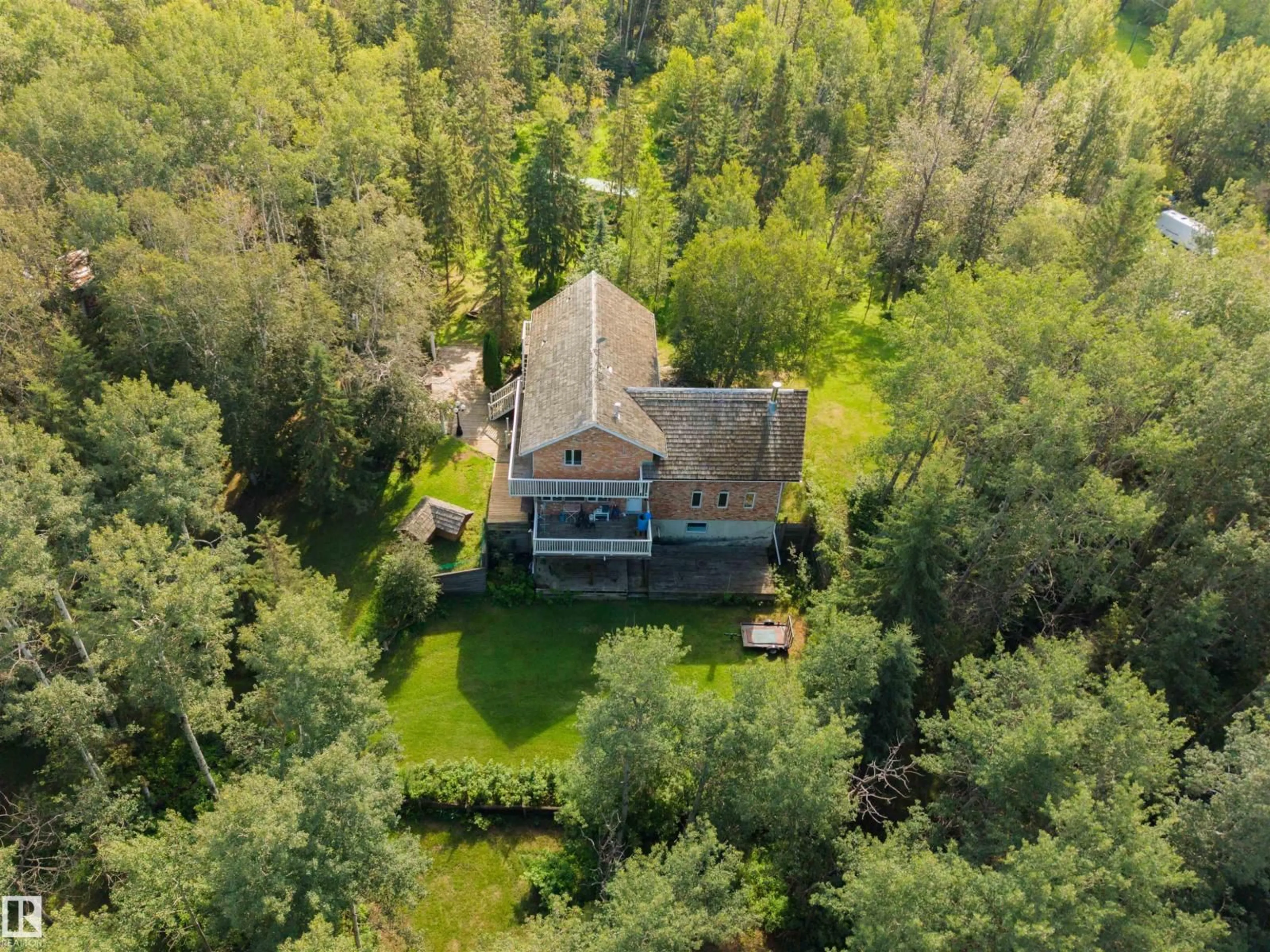 A pic from outside/outdoor area/front of a property/back of a property/a pic from drone, forest/trees view for #2 - 26320 TWP ROAD 514, Rural Parkland County Alberta T7Y1C8