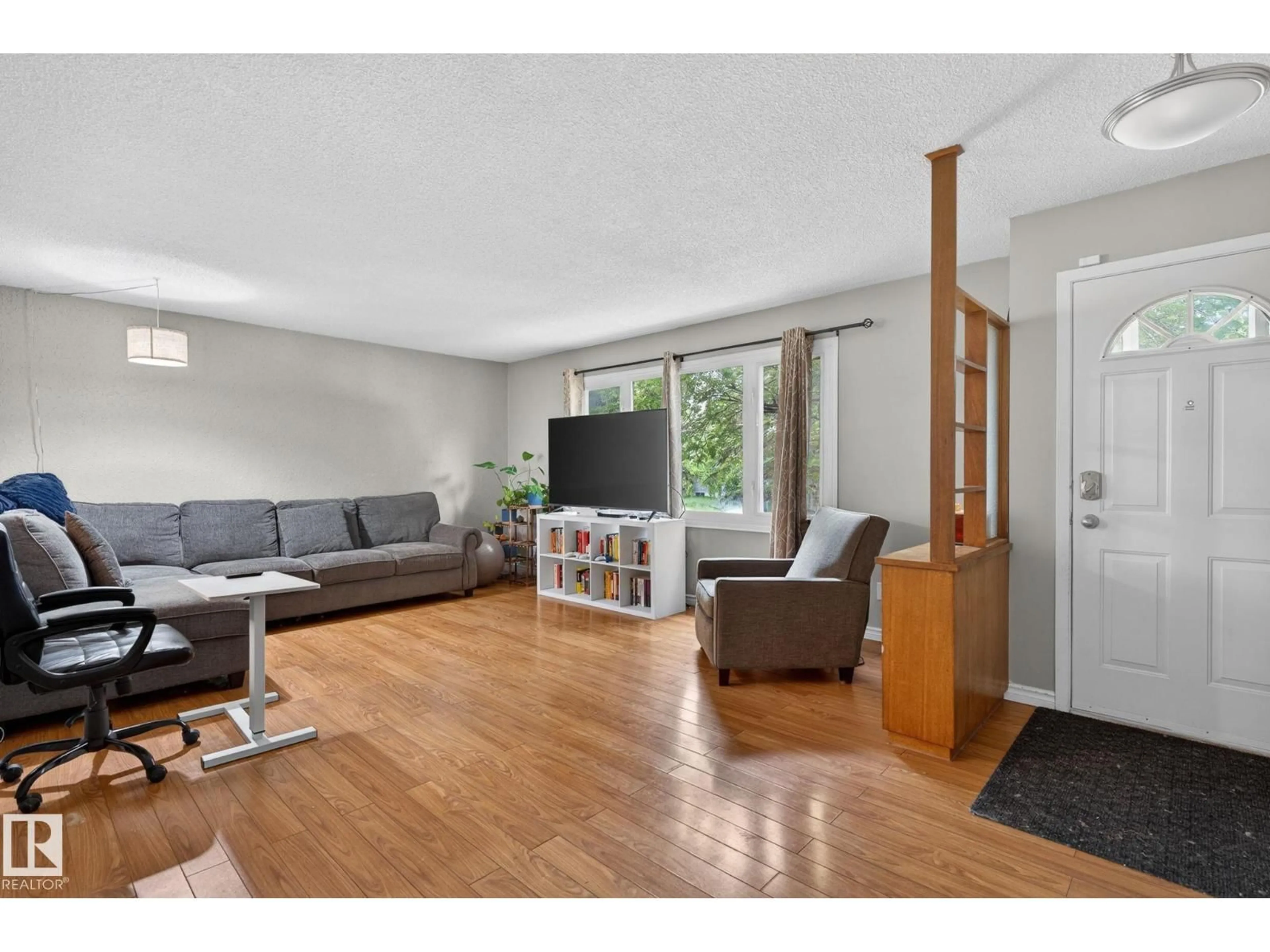 Living room with furniture, wood/laminate floor for 7804 136 AV NW, Edmonton Alberta T5C2K5