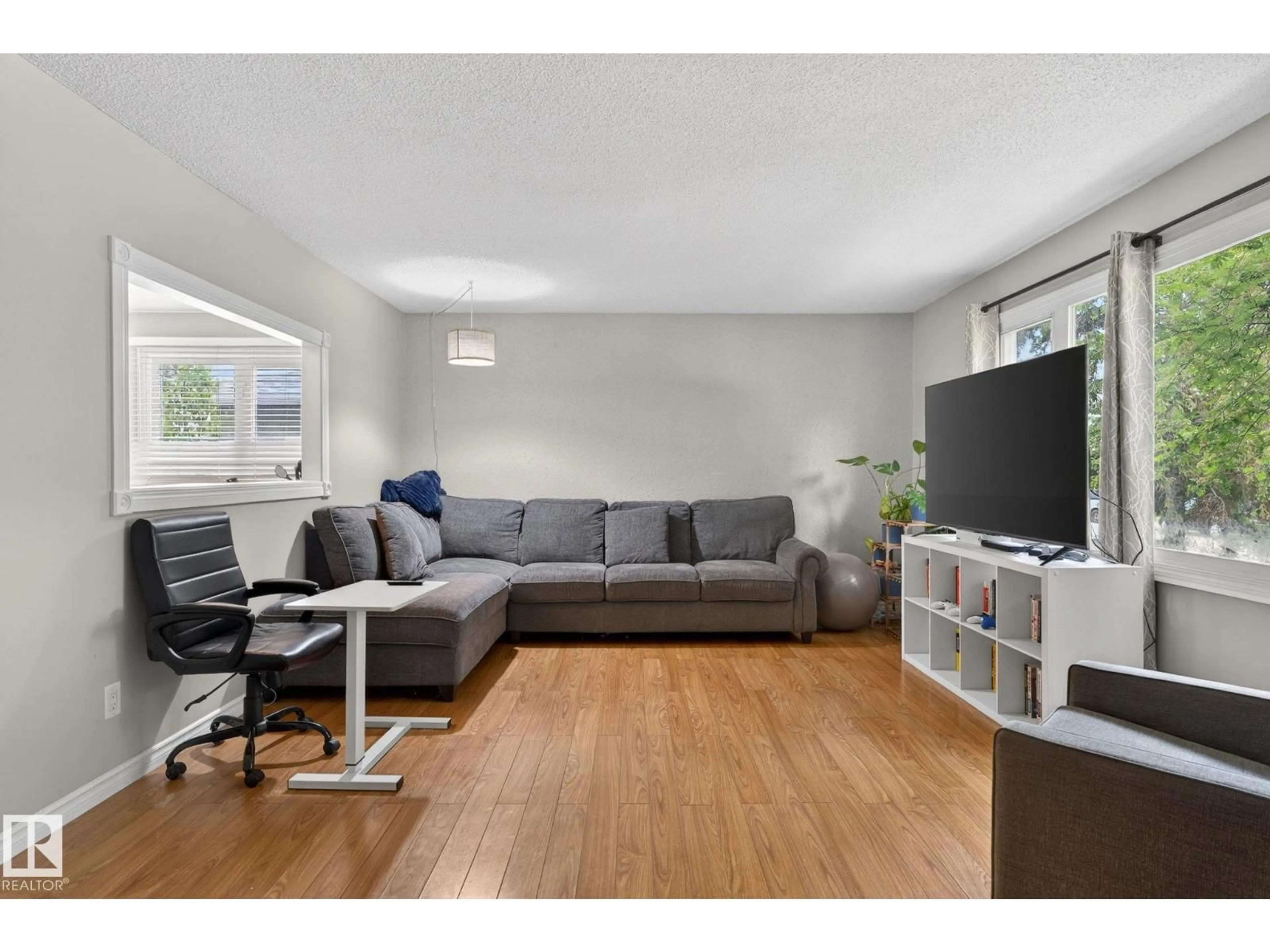 Living room with furniture, wood/laminate floor for 7804 136 AV NW, Edmonton Alberta T5C2K5