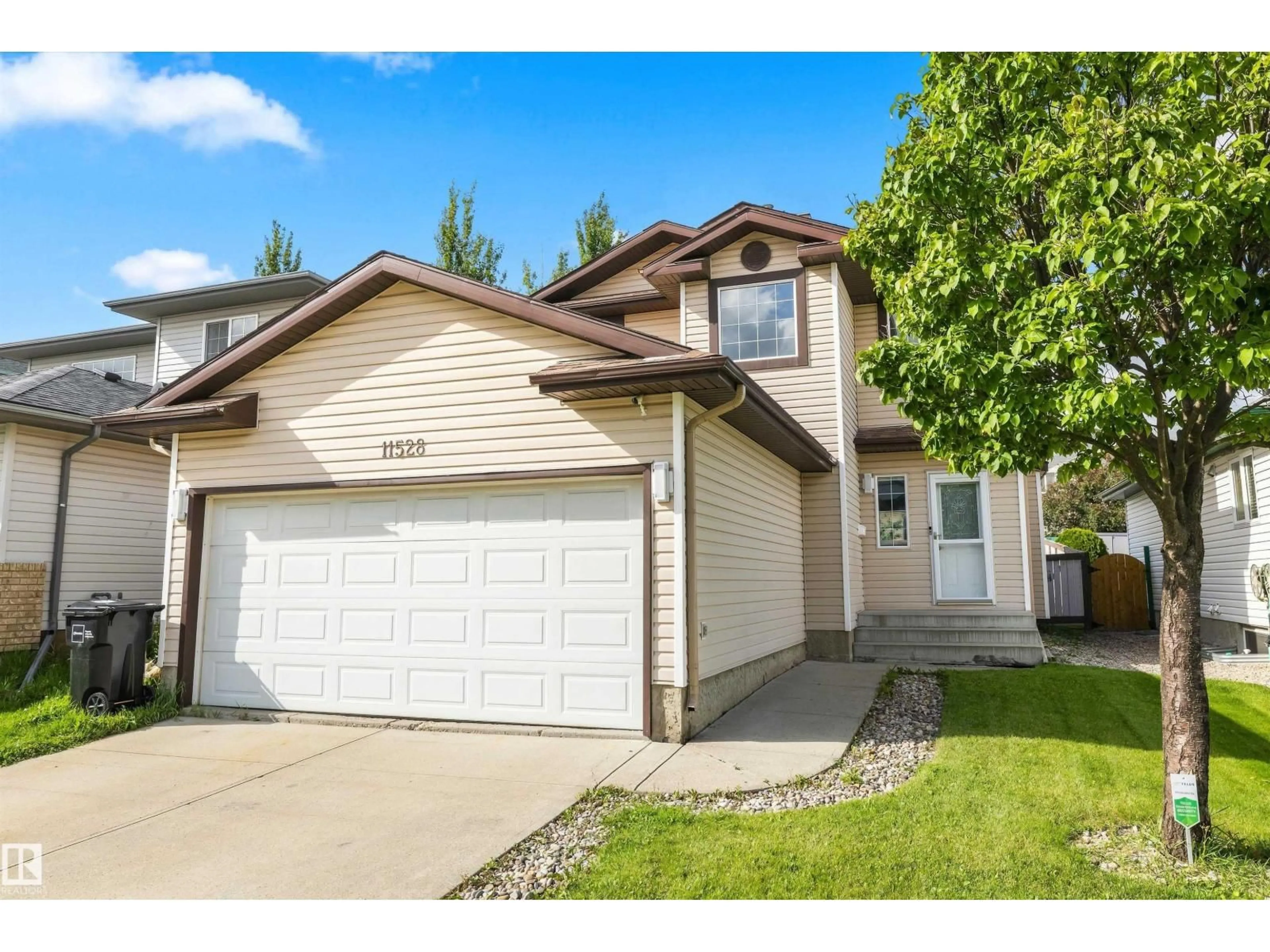 Home with vinyl exterior material, street for NW - 11528 168 AV, Edmonton Alberta T5X6B6