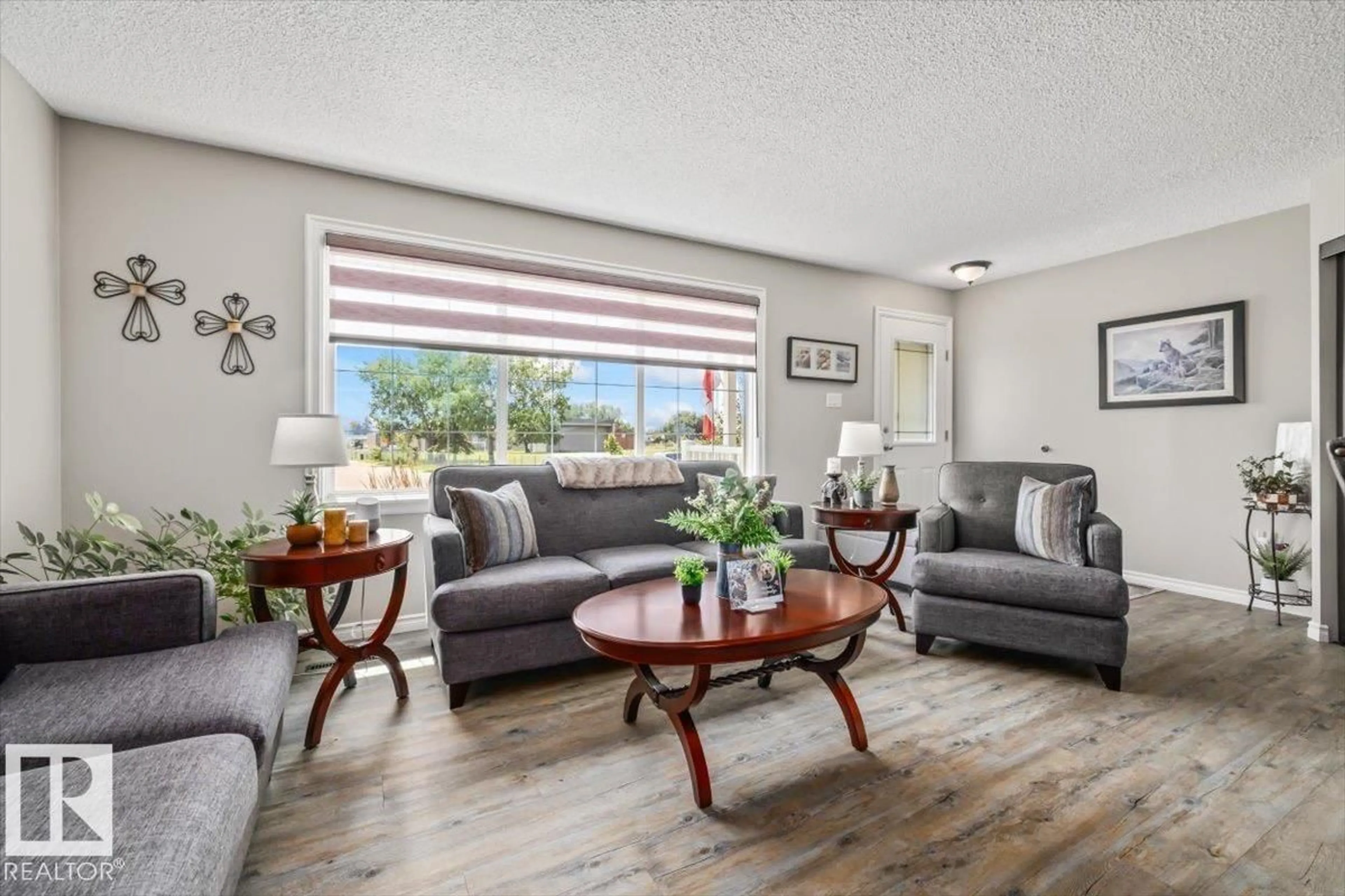 Living room with furniture, wood/laminate floor for 7408 133 AV, Edmonton Alberta T5C2E4
