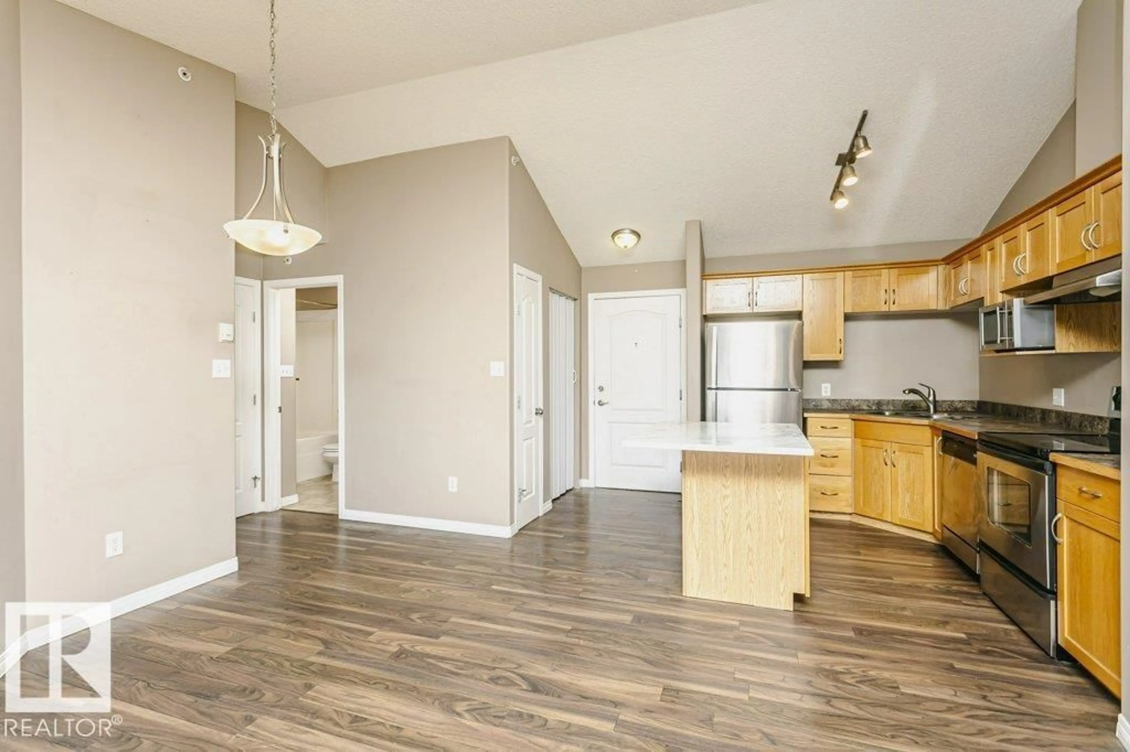 Open concept kitchen, wood/laminate floor for 411 - 3425 19 ST, Edmonton Alberta T6T2B5