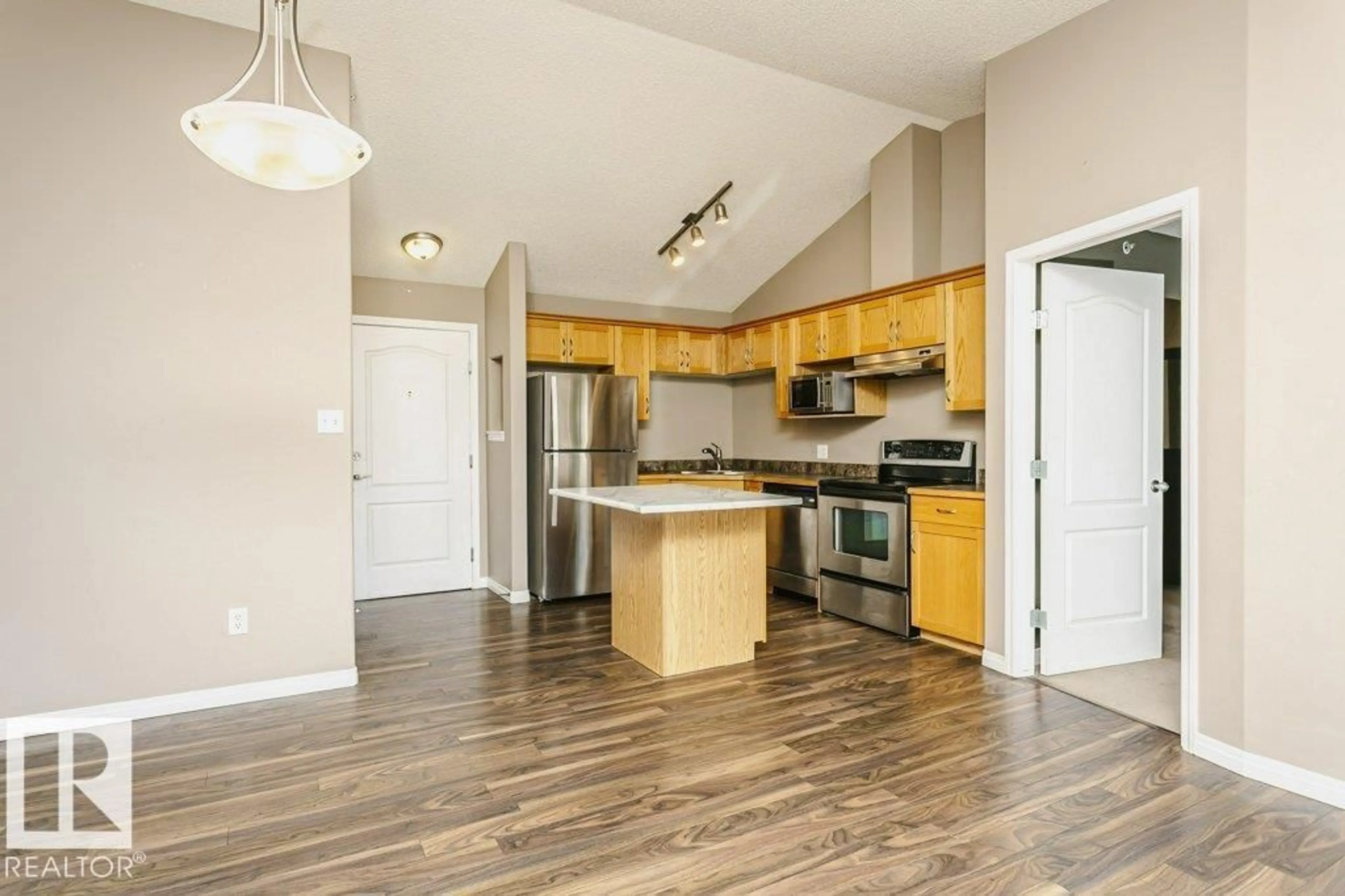 Open concept kitchen, wood/laminate floor for 411 - 3425 19 ST, Edmonton Alberta T6T2B5