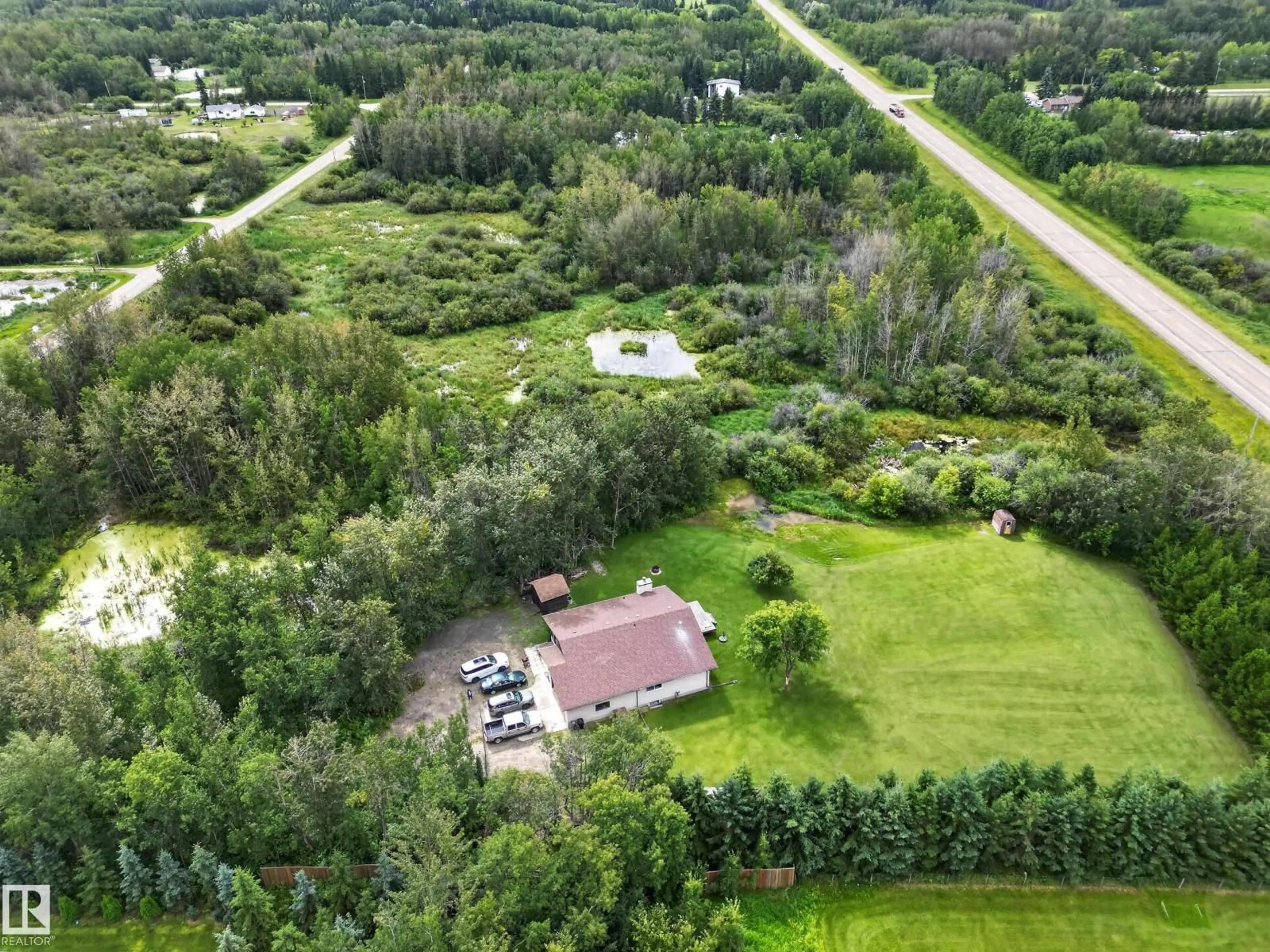 A pic from outside/outdoor area/front of a property/back of a property/a pic from drone, forest/trees view for 217 - 22169 TWP ROAD 530, Rural Strathcona County Alberta T8E2J1
