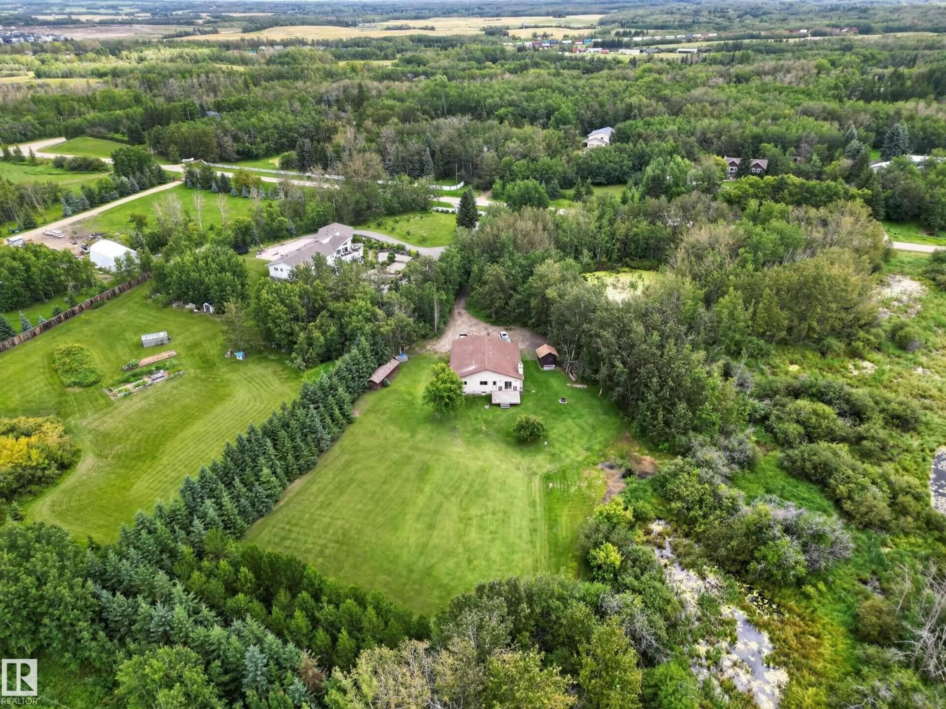 A pic from outside/outdoor area/front of a property/back of a property/a pic from drone, forest/trees view for 217 - 22169 TWP ROAD 530, Rural Strathcona County Alberta T8E2J1