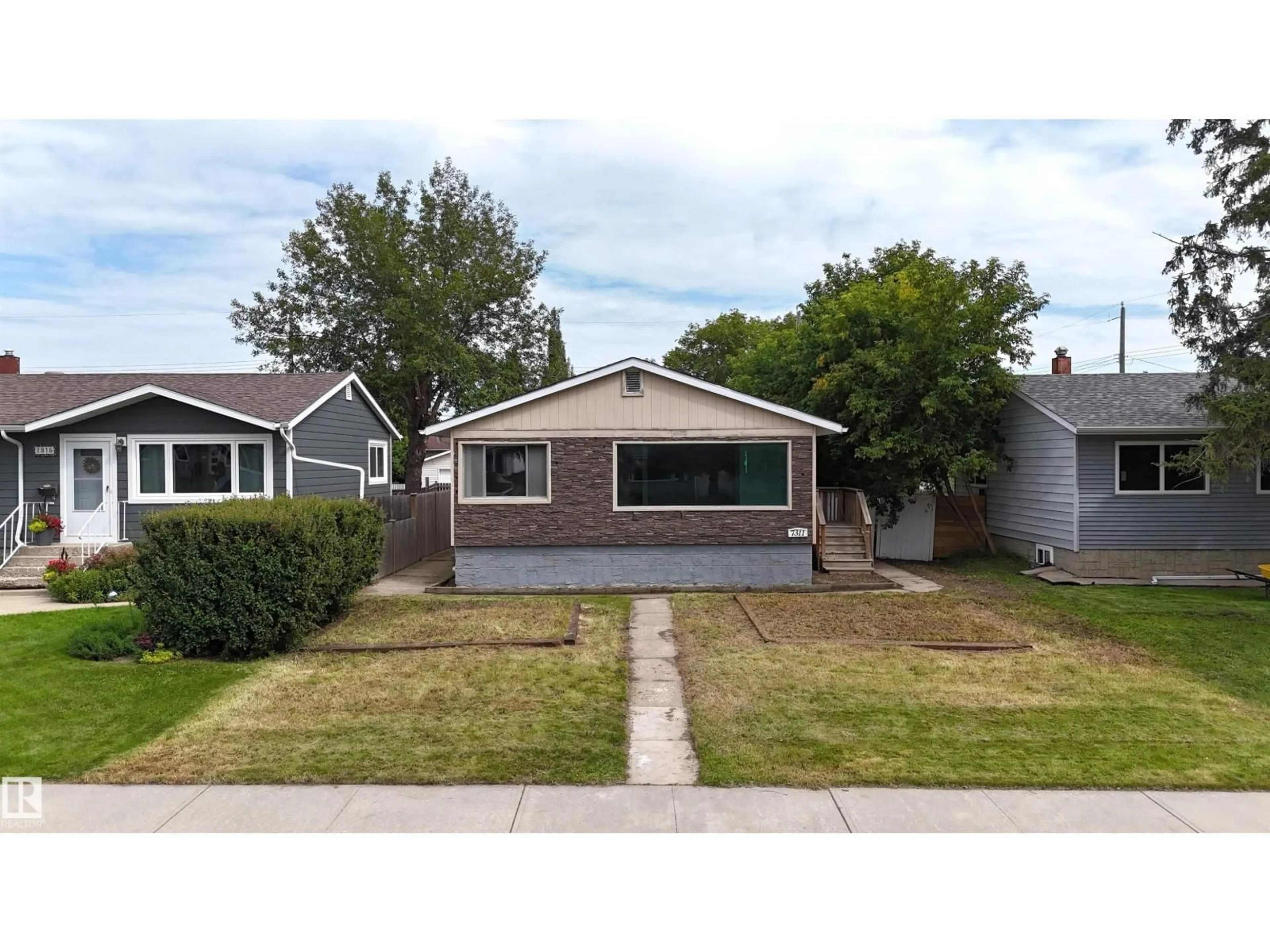 Home with vinyl exterior material, street for 7311 77 ST, Edmonton Alberta T6C2L3