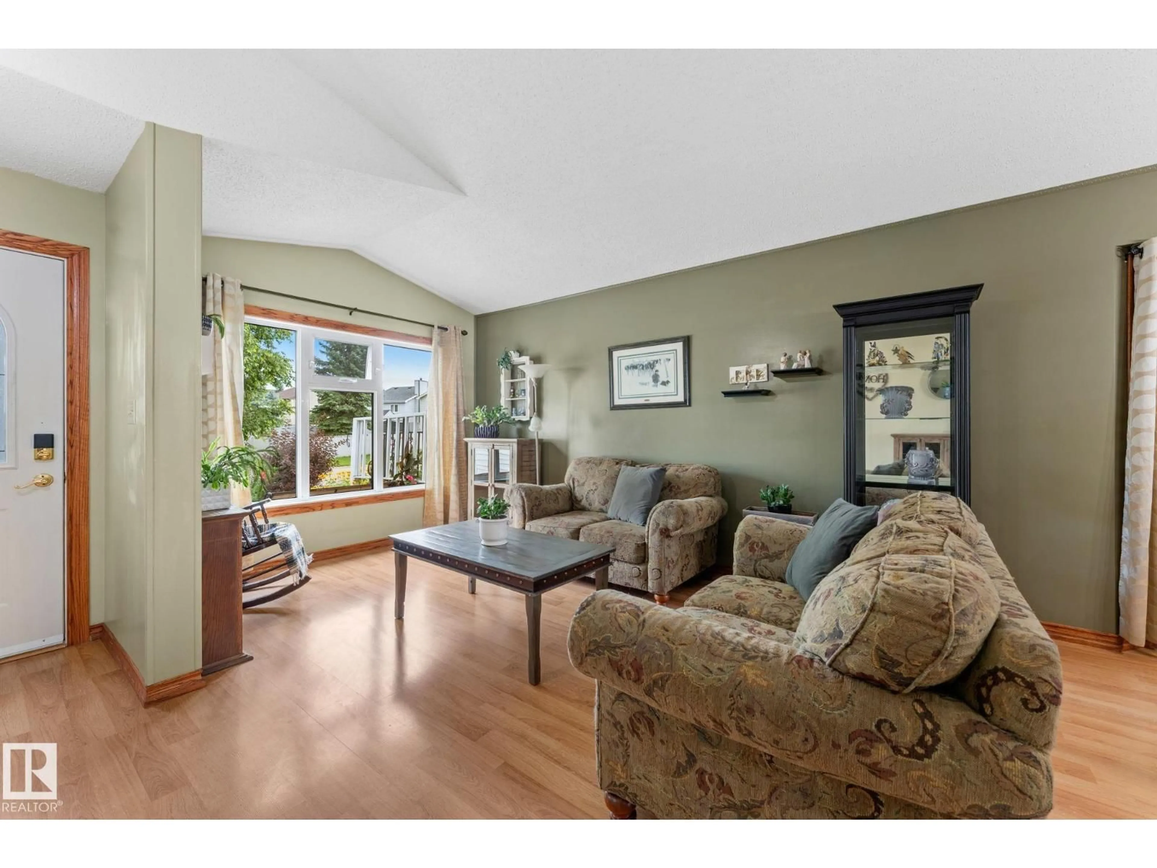 Living room with furniture, wood/laminate floor for 4224 33A ST, Edmonton Alberta T6T1E7