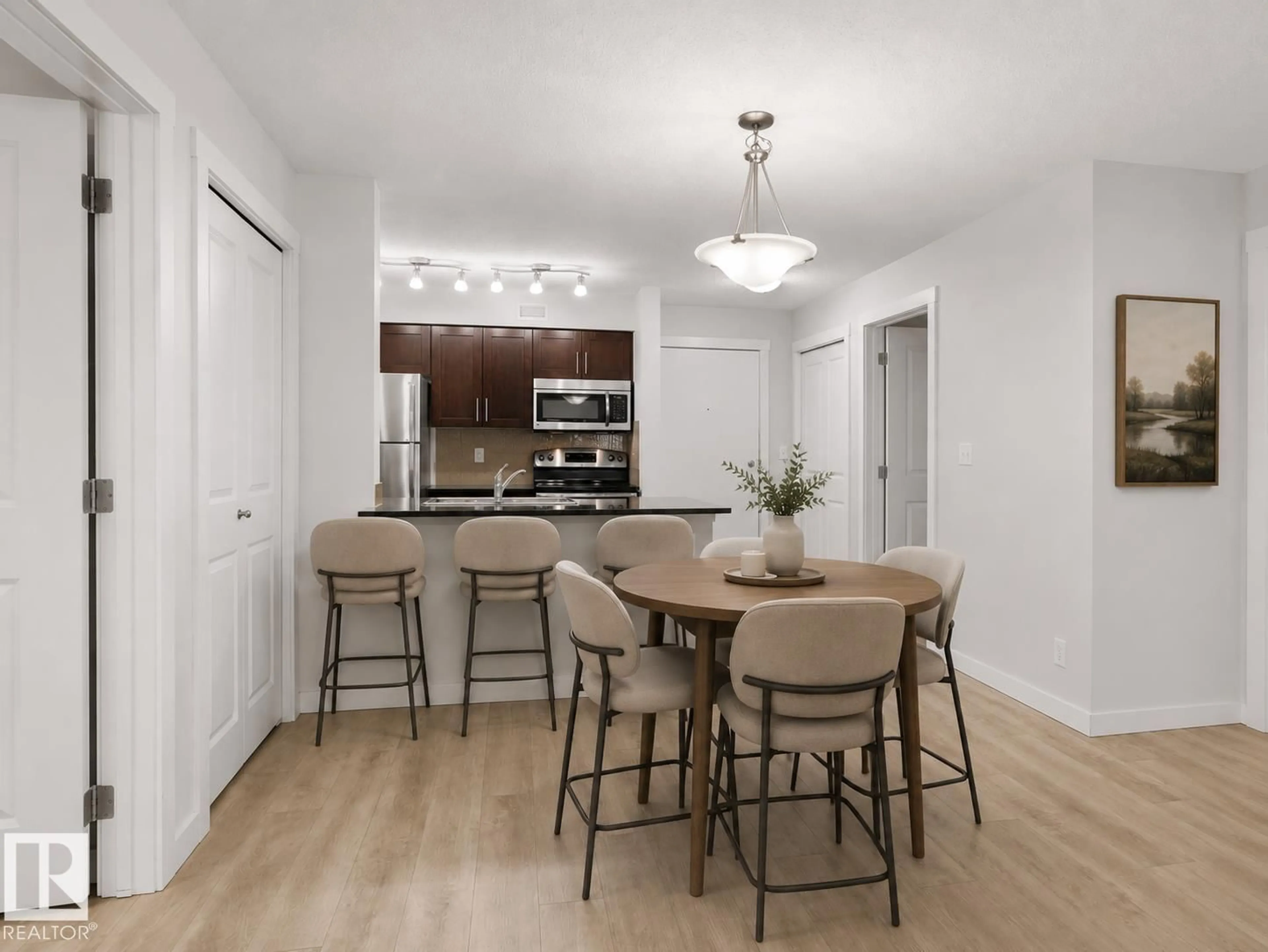 Open concept kitchen, wood/laminate floor for #205 - 5816 MULLEN PL, Edmonton Alberta T6R0W3