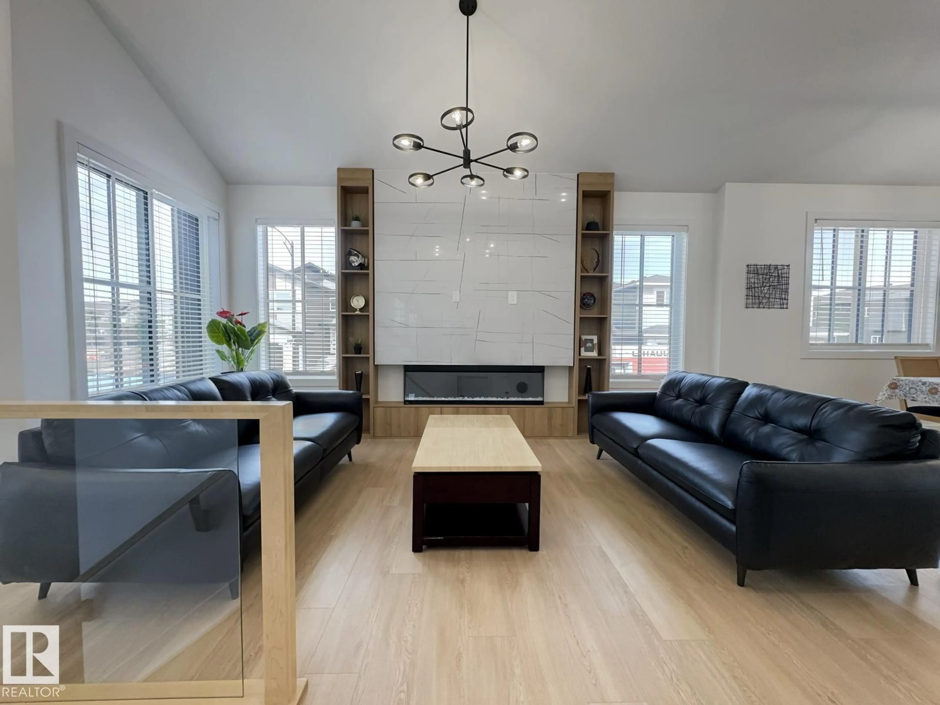 Living room with furniture, wood/laminate floor for 8903 MAYDAY WY, Edmonton Alberta T6X3E6