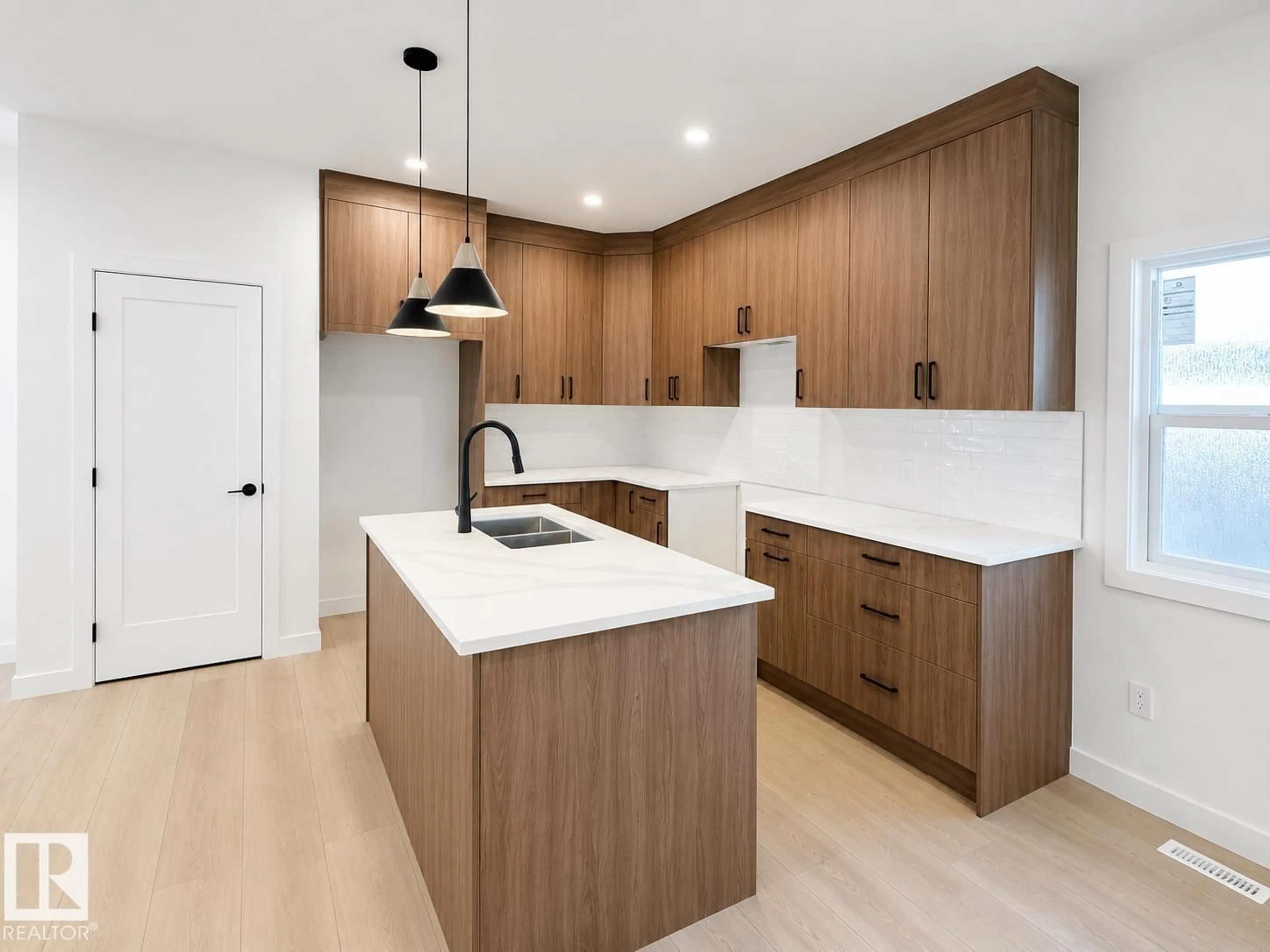 Open concept kitchen, wood/laminate floor for 11642/44 94STREET NW, Edmonton Alberta T5G1H8
