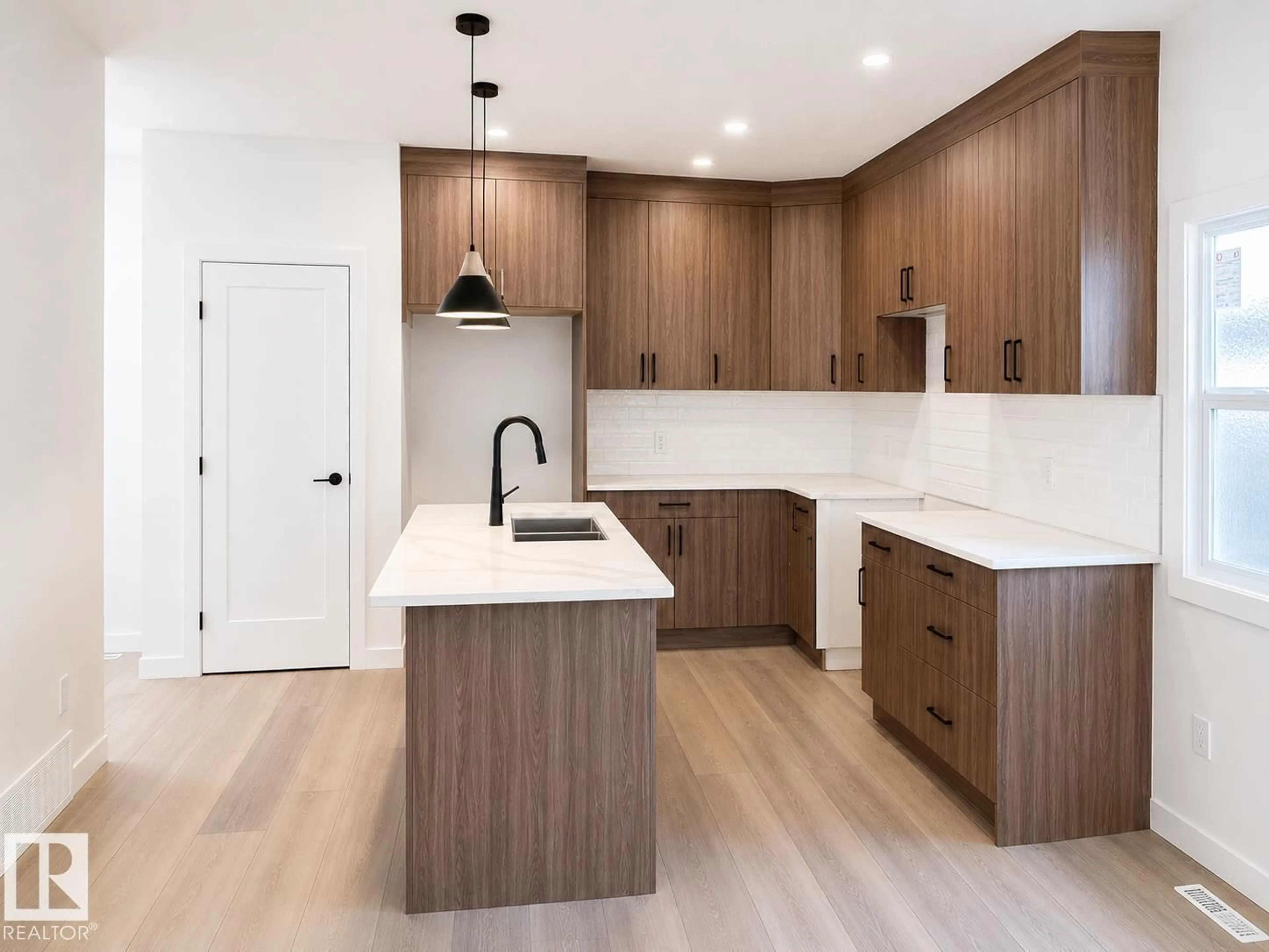 Open concept kitchen, wood/laminate floor for 11642/44 94STREET NW, Edmonton Alberta T5G1H8