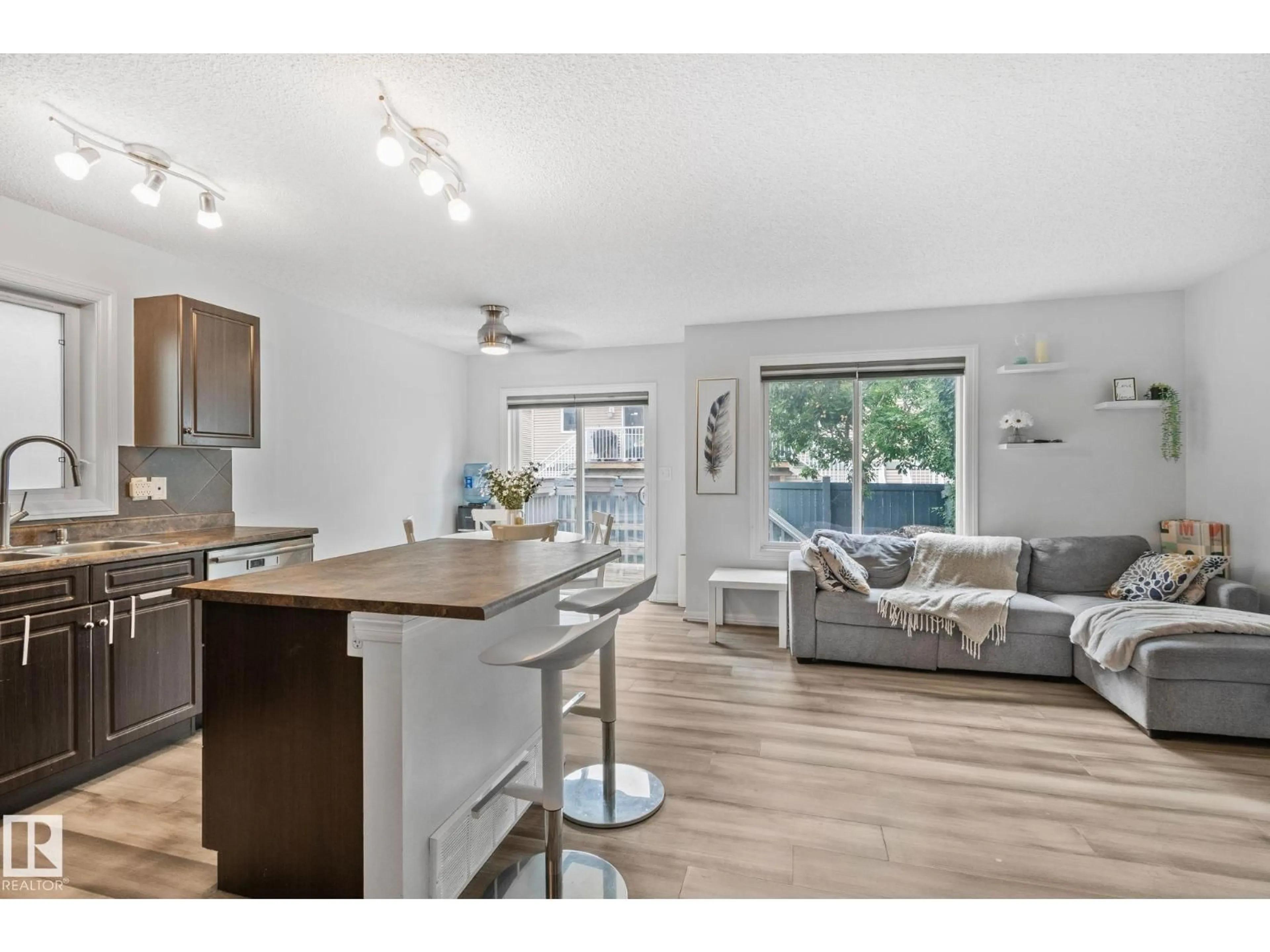 Open concept kitchen, wood/laminate floor for 5101 - 20 SOLEIL BV, Beaumont Alberta T4X0E3