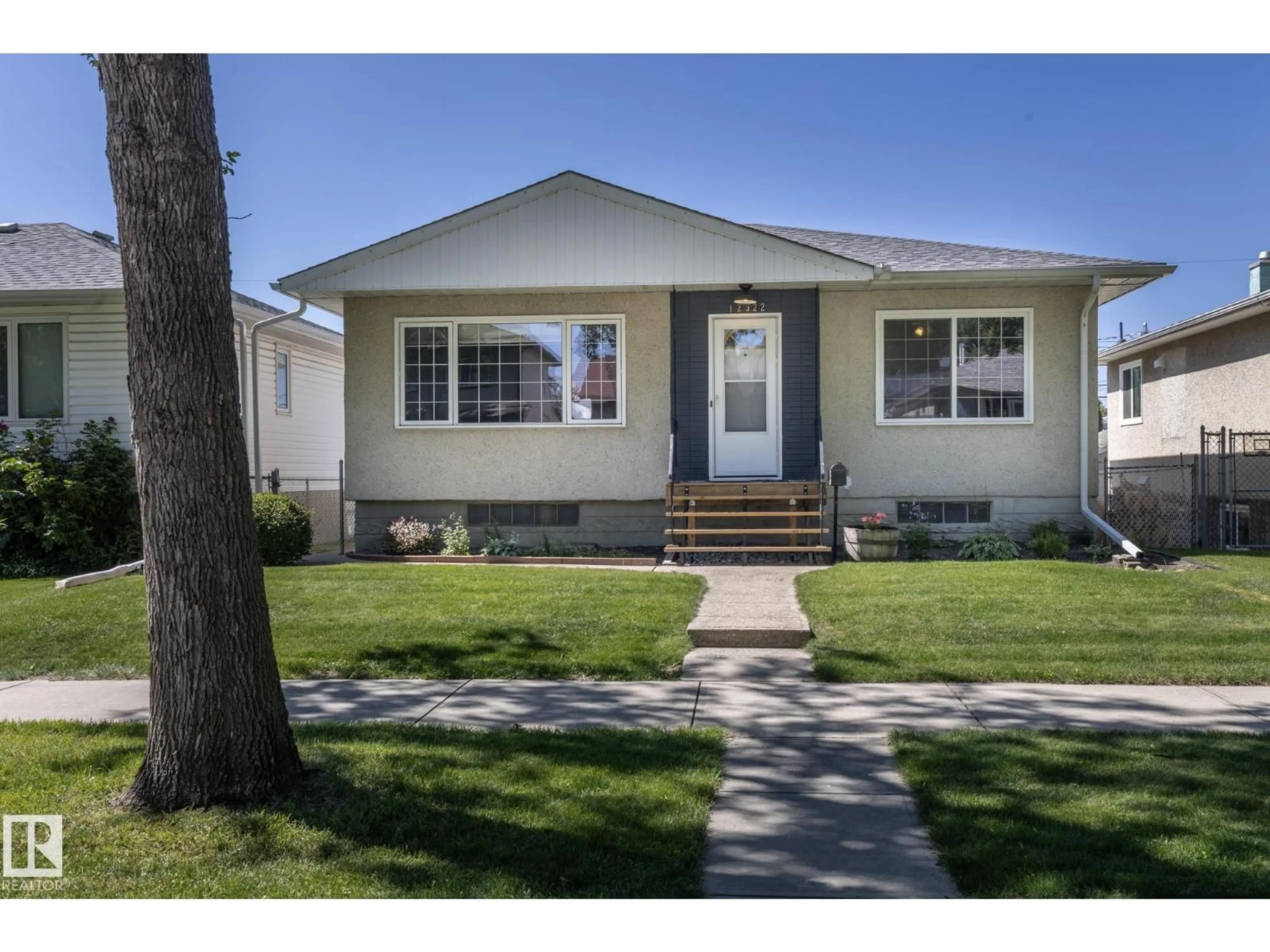 Home with vinyl exterior material, street for 12322 94 ST, Edmonton Alberta T5G1K3