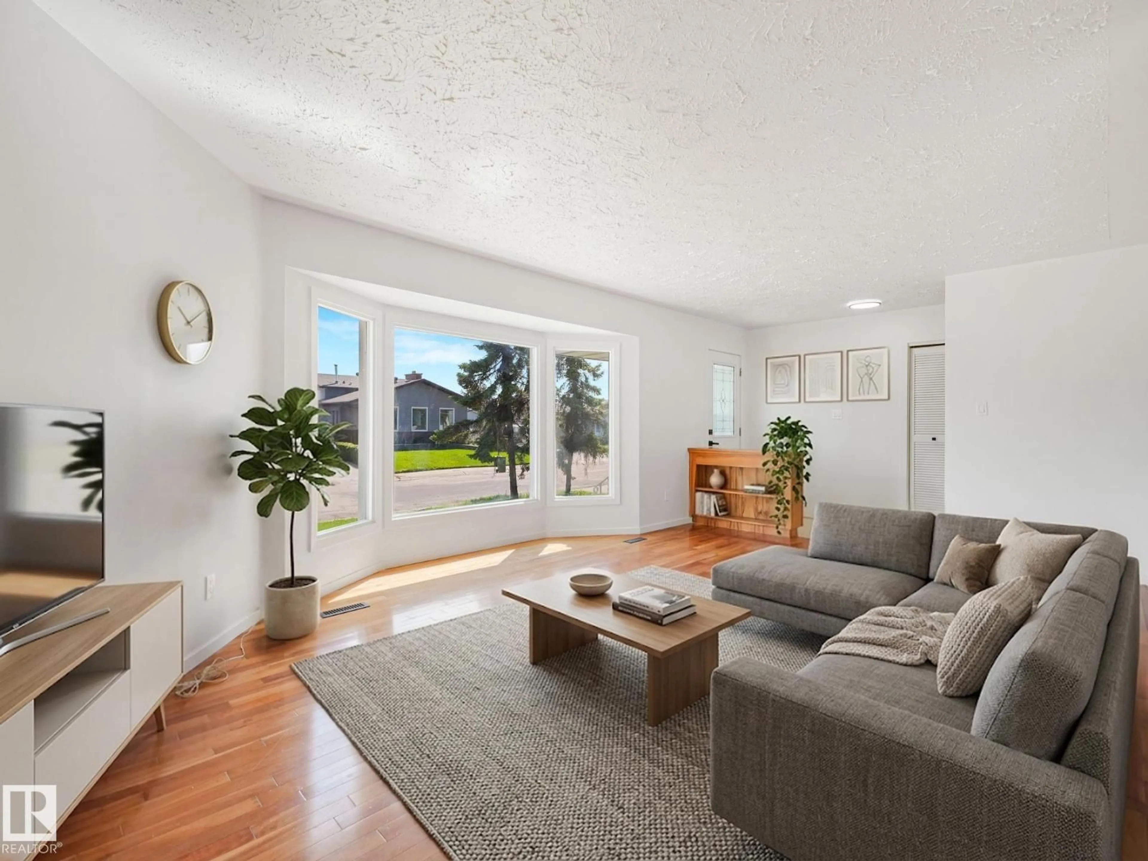 Living room with furniture, wood/laminate floor for 11616 158 AV, Edmonton Alberta T5X2K4