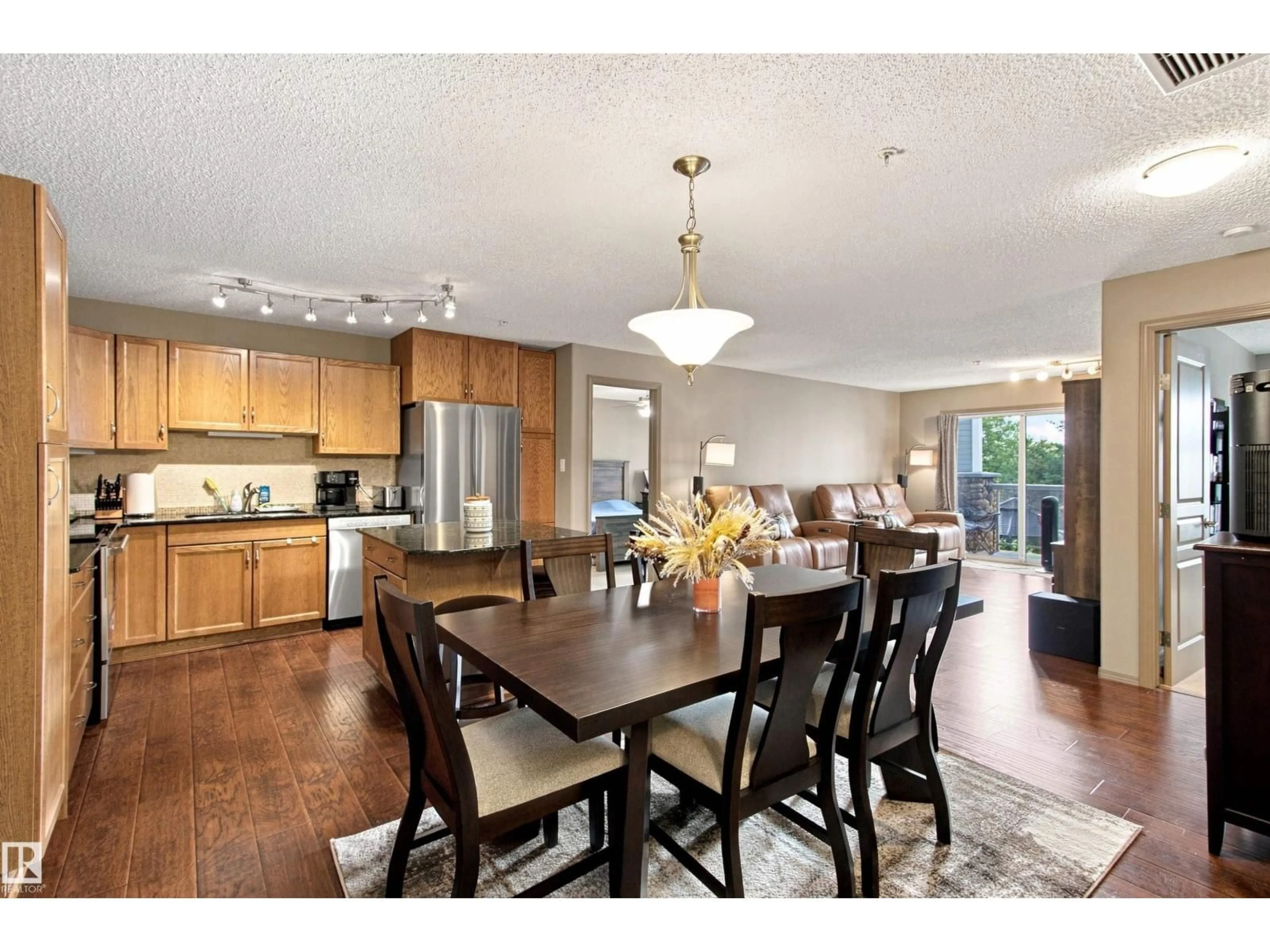 Open concept kitchen, wood/laminate floor for #219 - 16035 132 ST, Edmonton Alberta T6V0B4