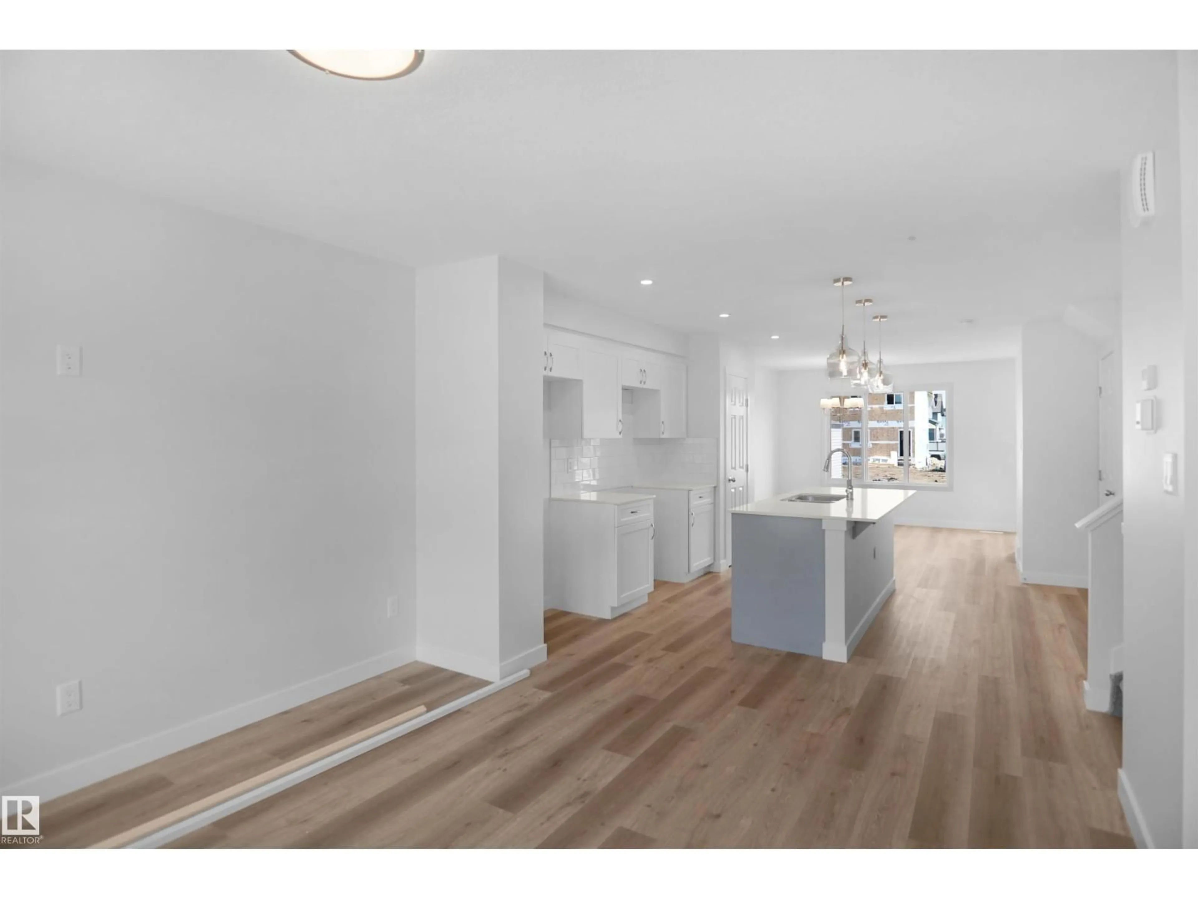 Open concept kitchen, wood/laminate floor for NW - 20847 16 AV, Edmonton Alberta T6M1L2