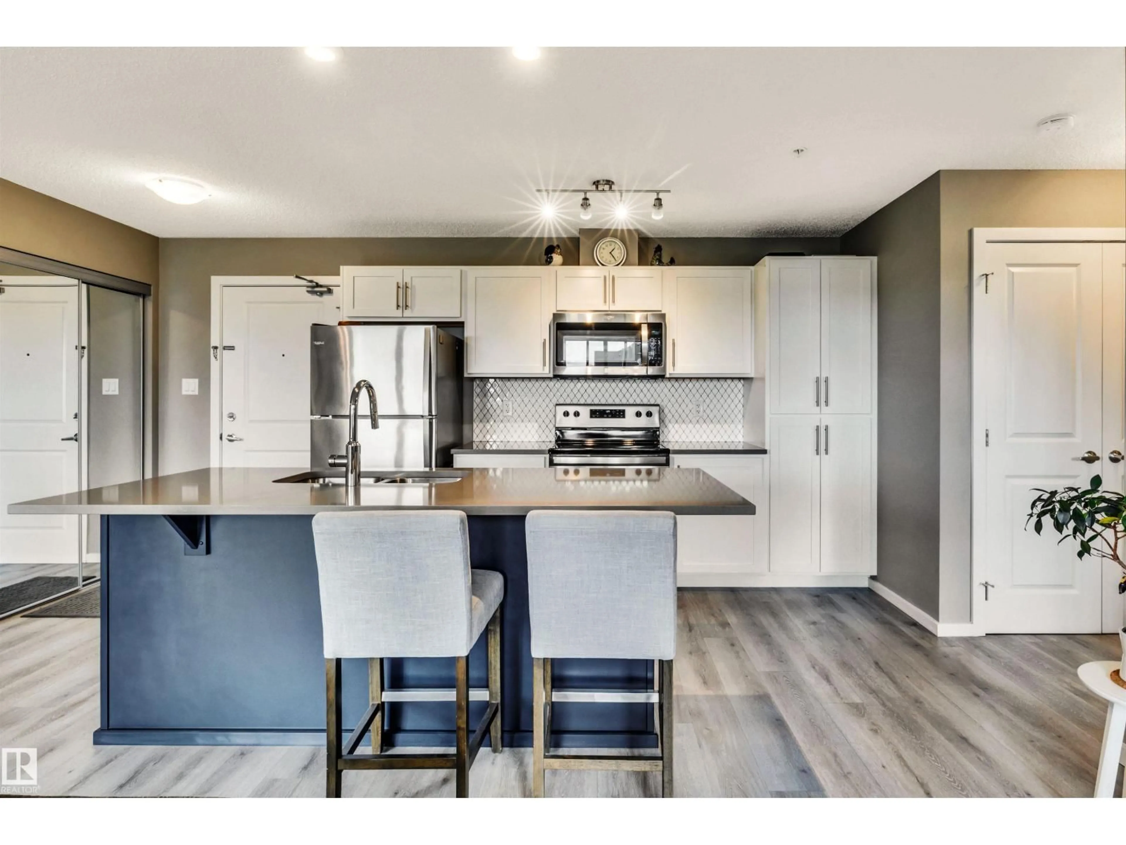 Open concept kitchen, wood/laminate floor for 148 - 226 EBBERS BV, Edmonton Alberta T5Y4A4