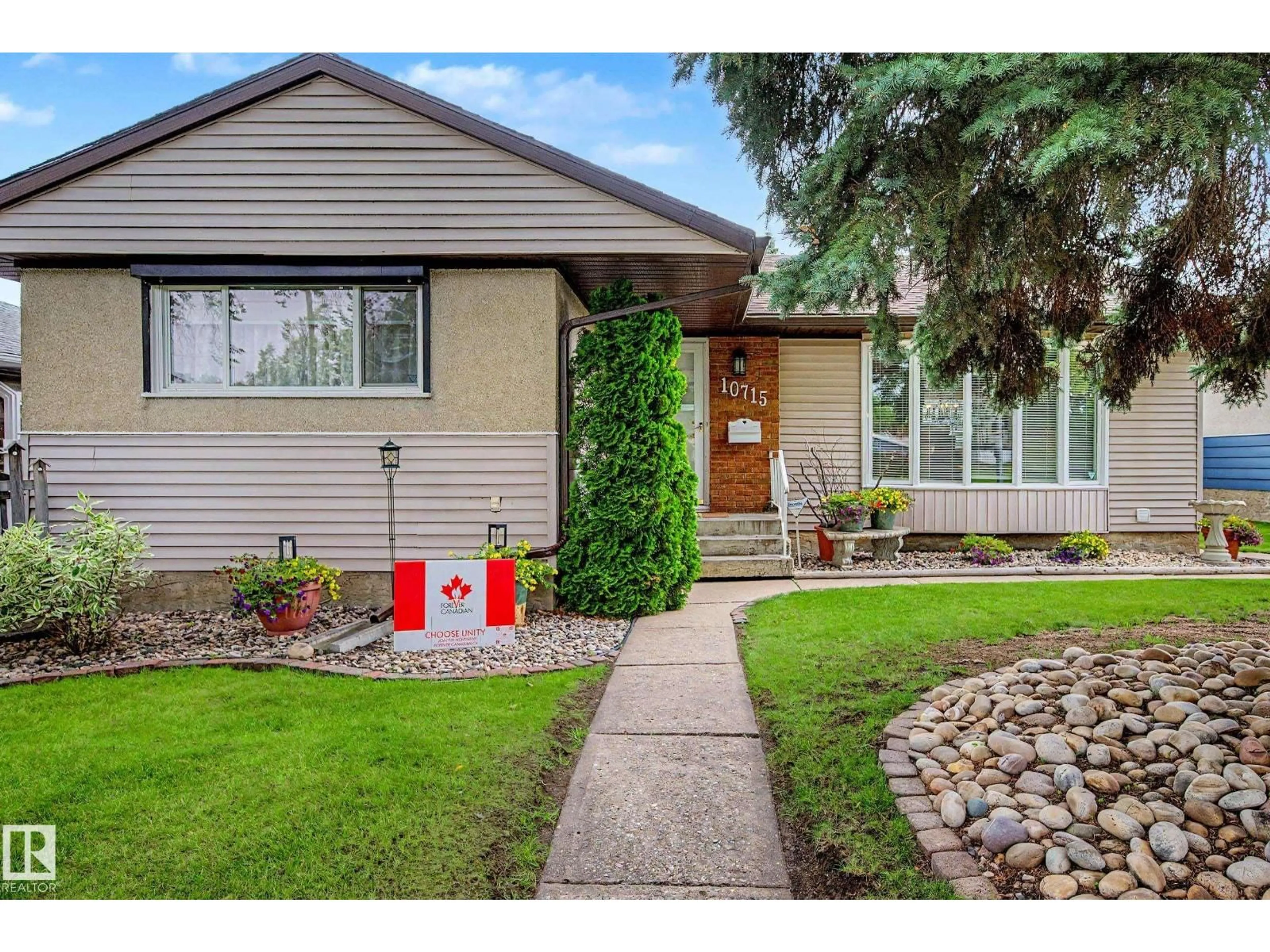 Home with vinyl exterior material, street for NW - 10715 50 ST, Edmonton Alberta T6A2E3