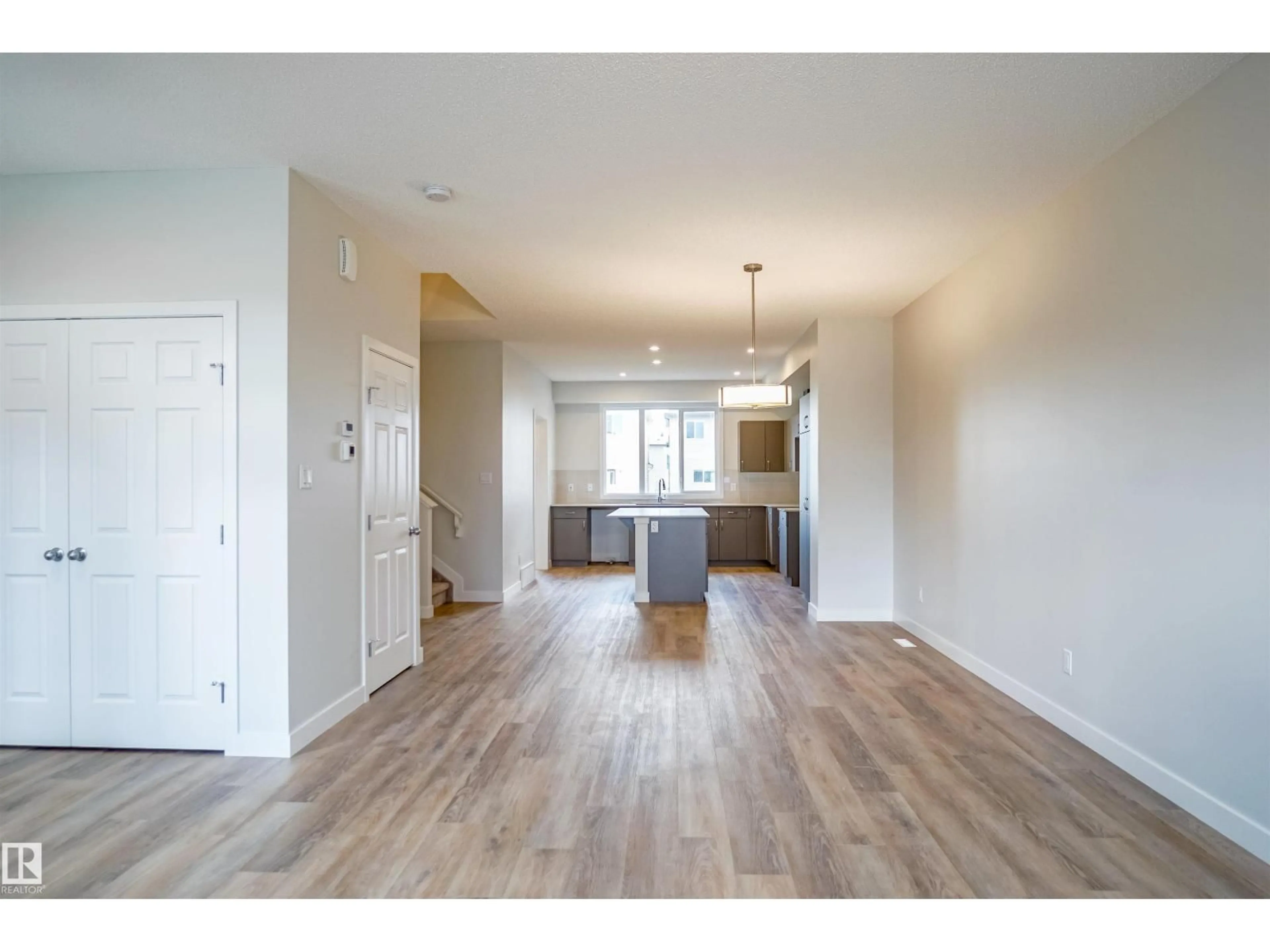 Open concept kitchen, wood/laminate floor for NW - 21148 25 AV, Edmonton Alberta T6M2N6
