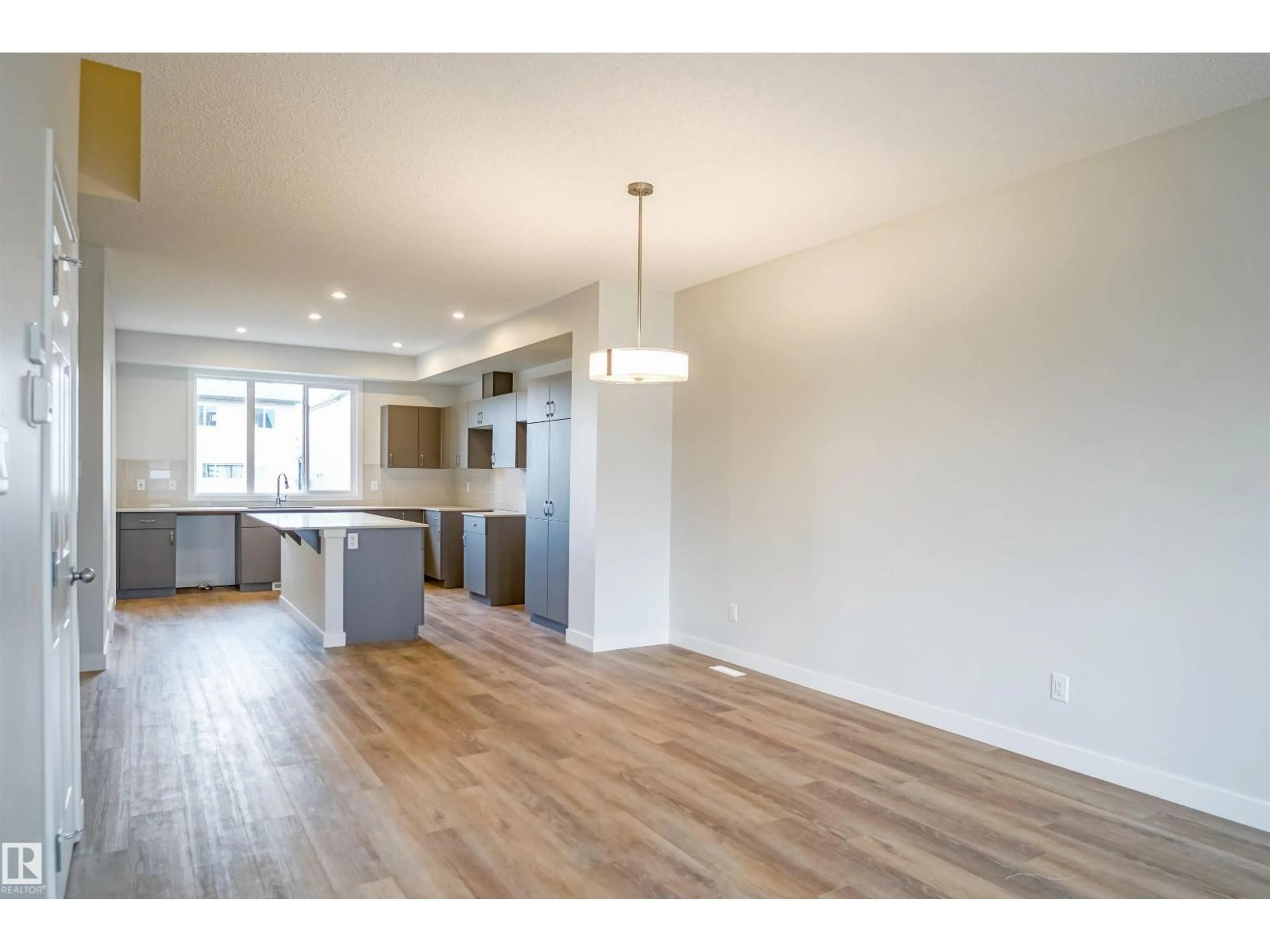 Open concept kitchen, wood/laminate floor for NW - 21148 25 AV, Edmonton Alberta T6M2N6