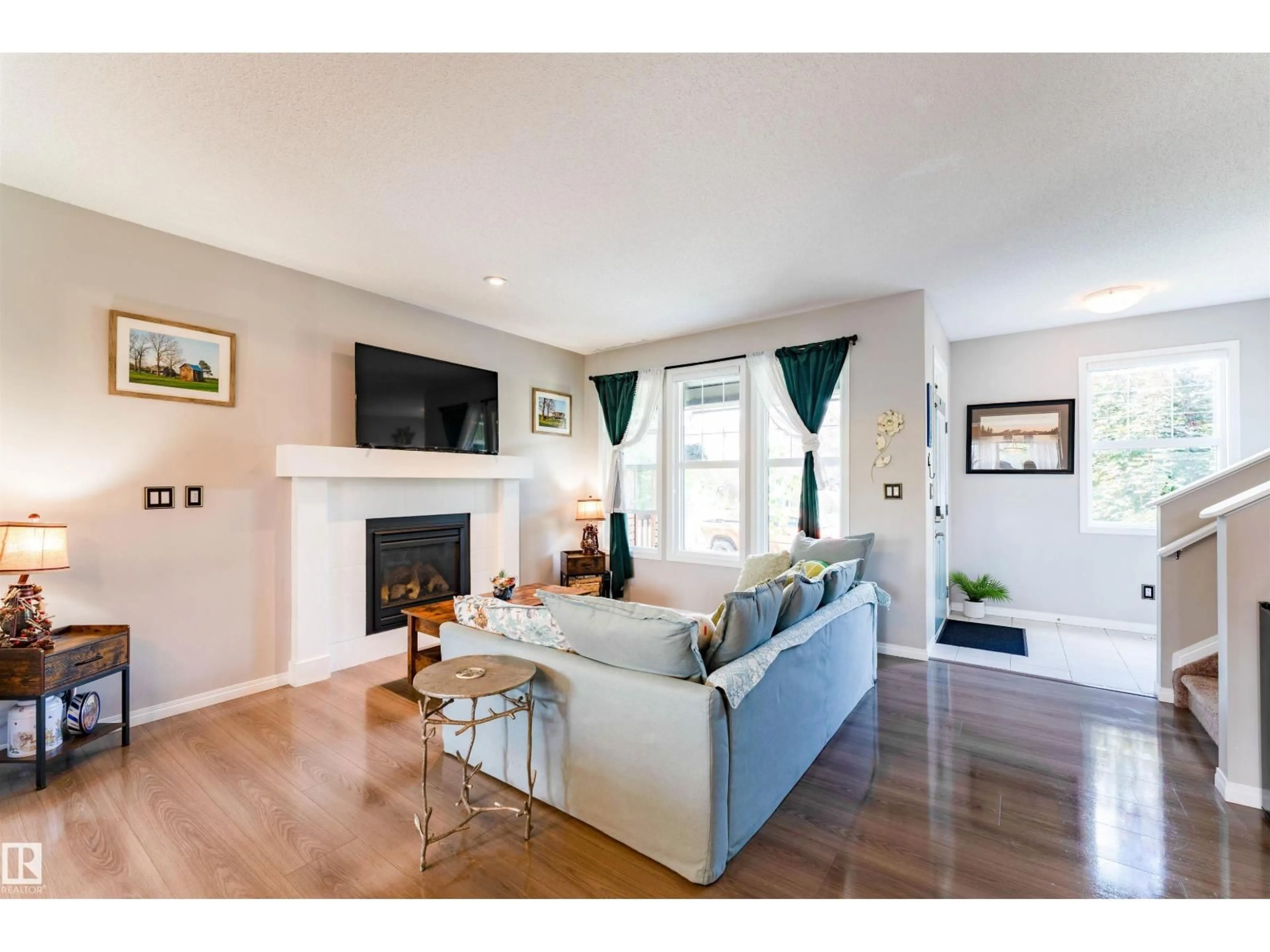 Living room with furniture, wood/laminate floor for 725 SECORD BV, Edmonton Alberta T5T7A8