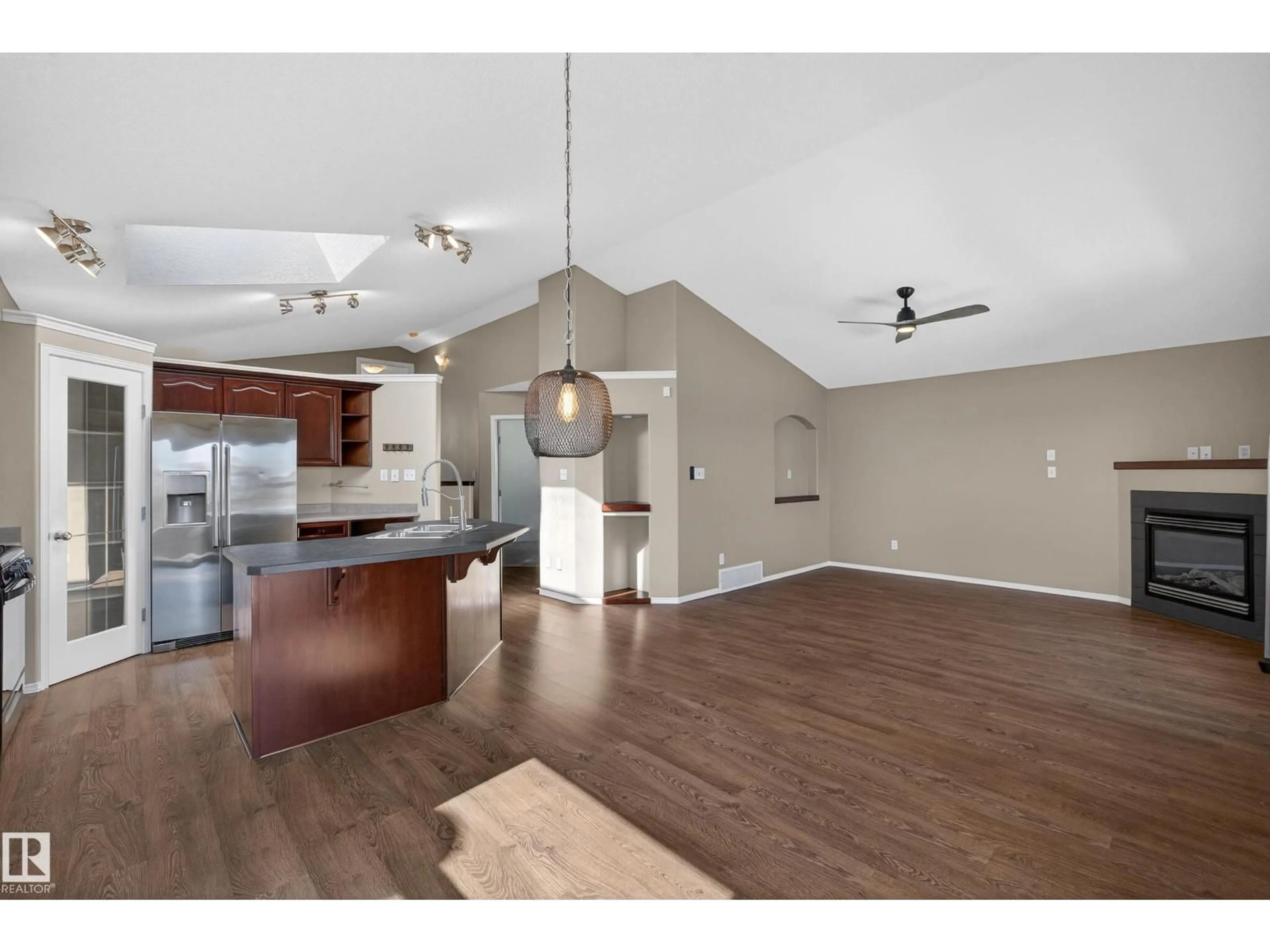 Open concept kitchen, wood/laminate floor for 3779 18 ST, Edmonton Alberta T6T1S5
