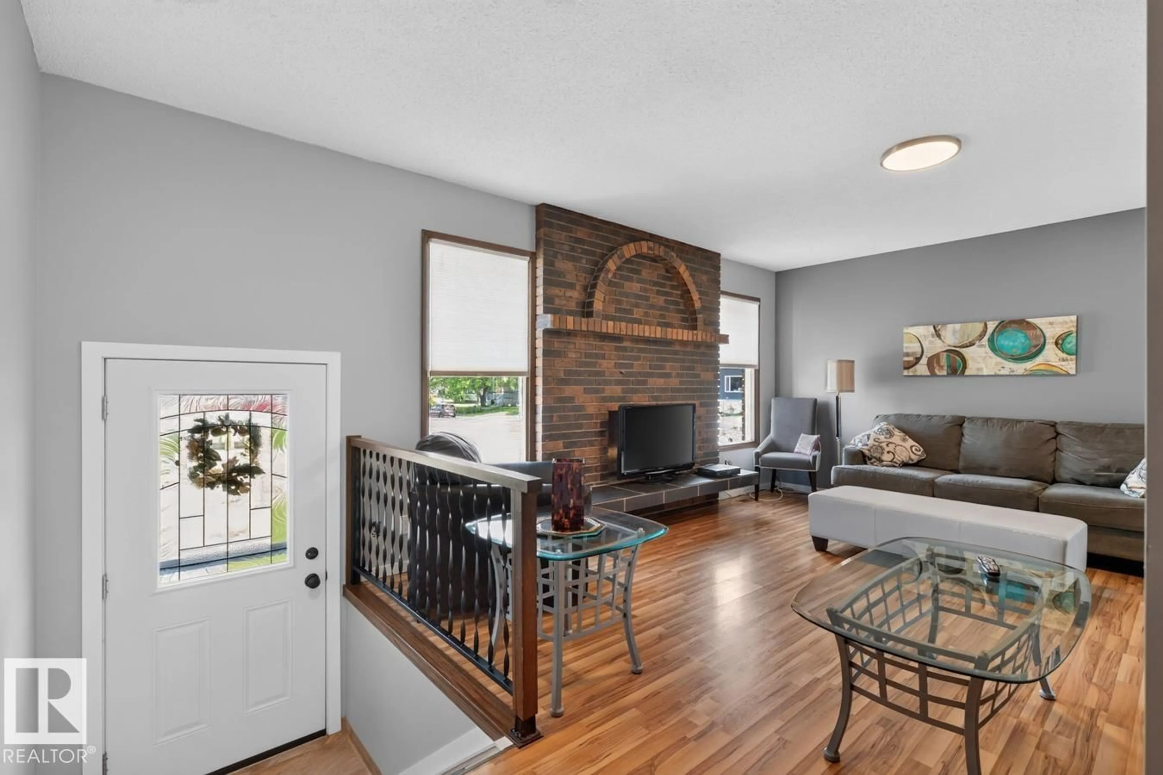 Living room with furniture, wood/laminate floor for 2408 80 ST, Edmonton Alberta T6K3P6