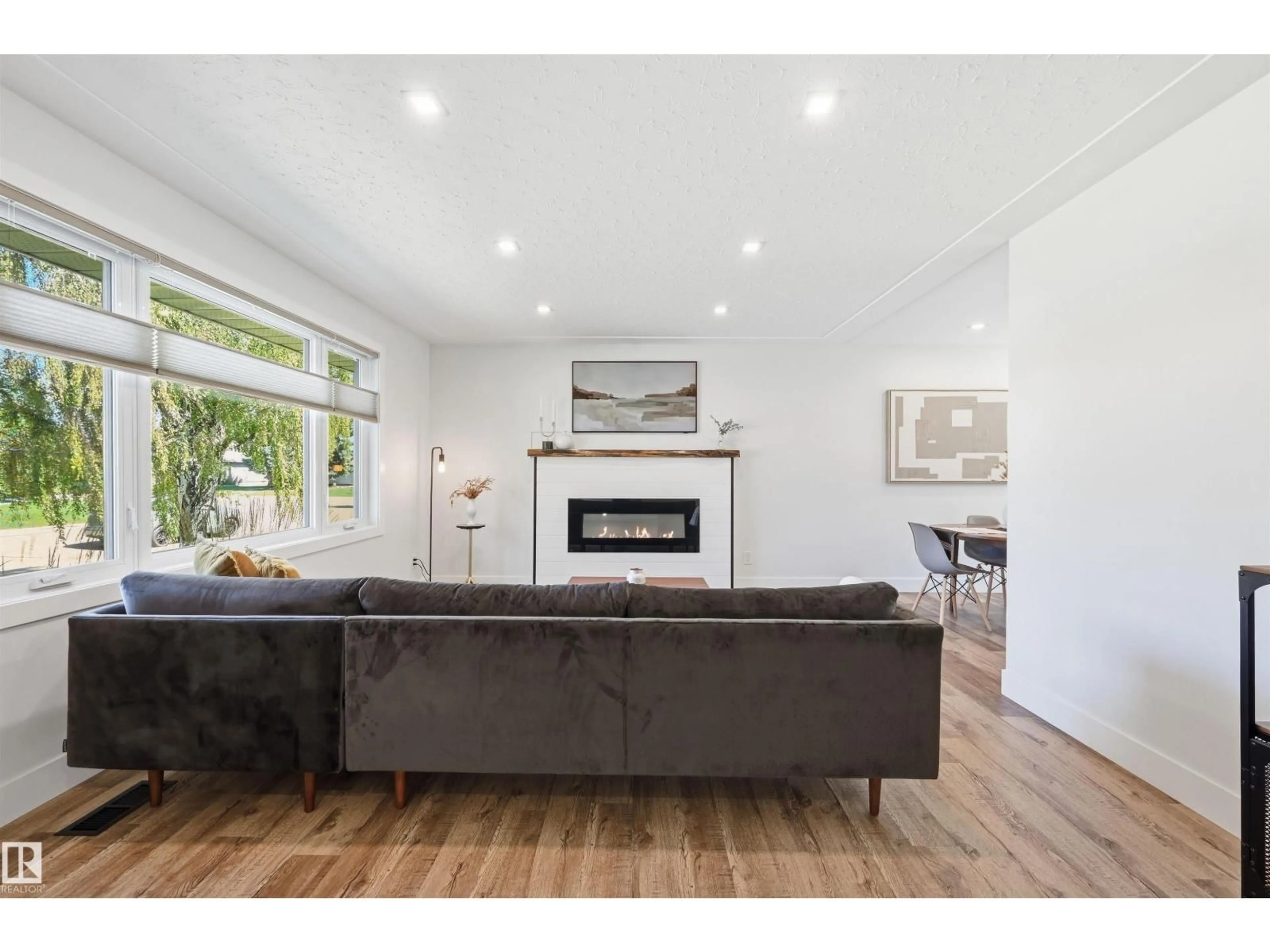 Living room with furniture, wood/laminate floor for 6015 92A AV, Edmonton Alberta T6B0T3