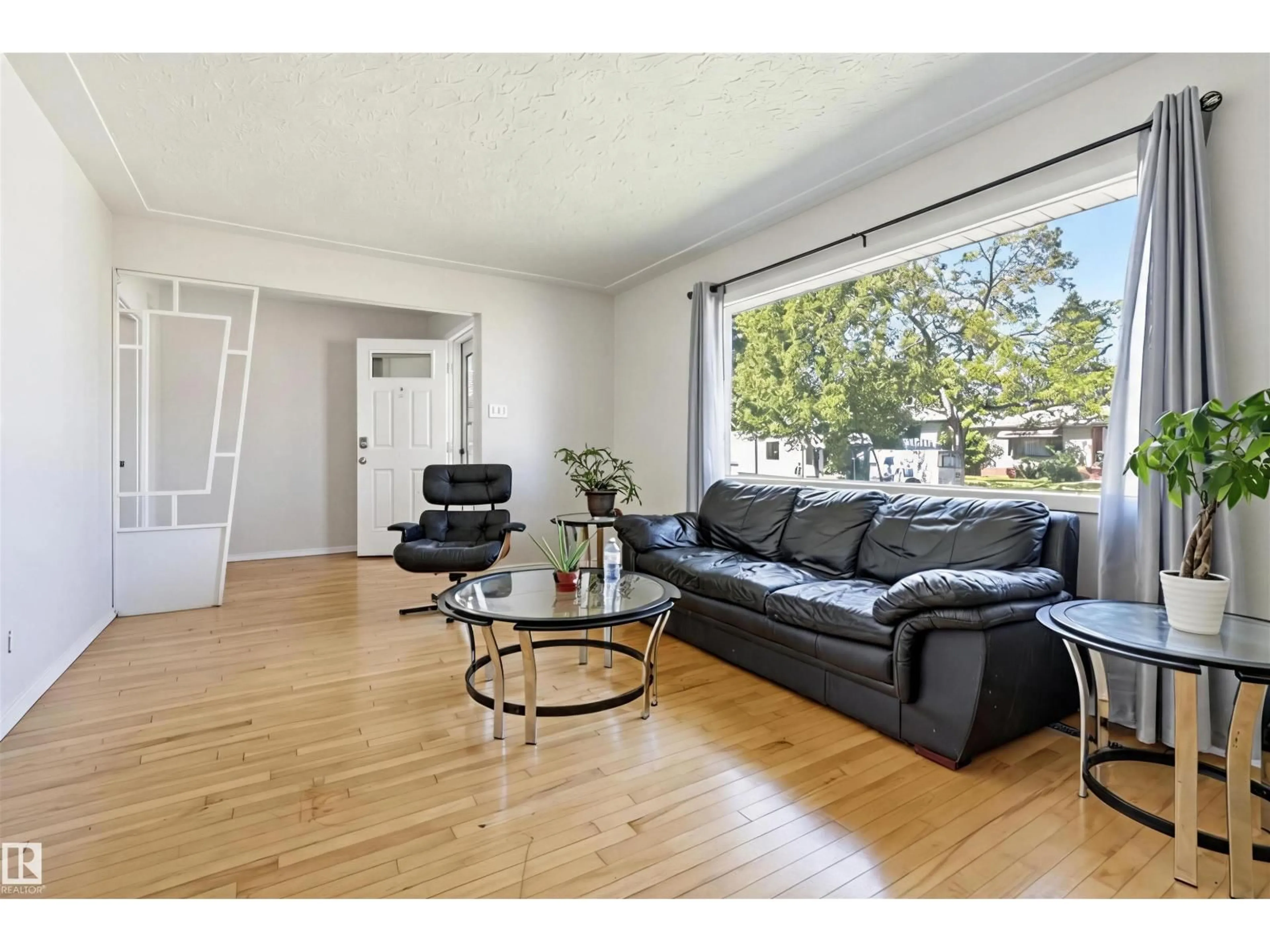 Living room with furniture, wood/laminate floor for 10423 64 AV, Edmonton Alberta T6H1S8