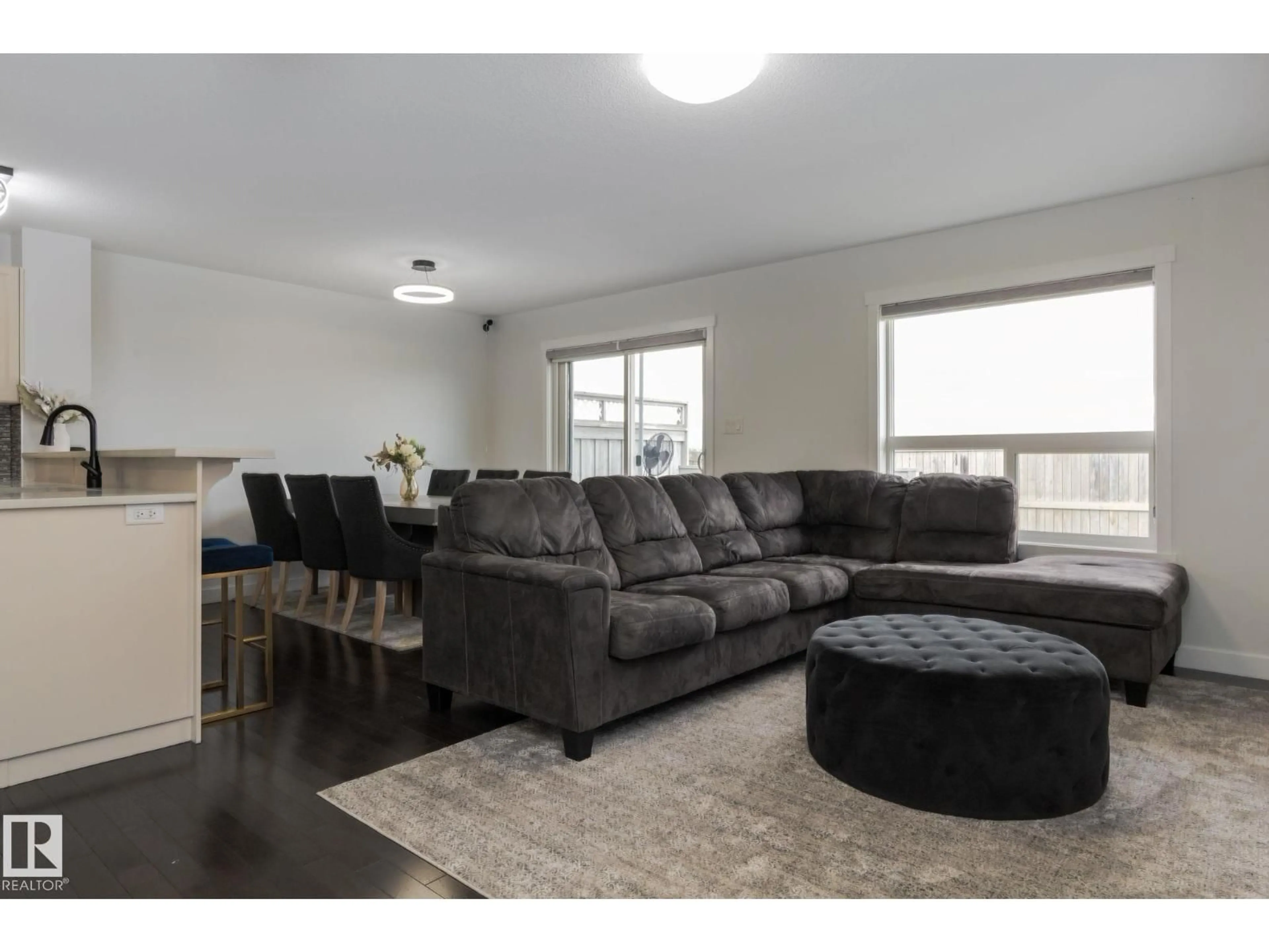Living room with furniture, wood/laminate floor for SW - 5112 1A AV, Edmonton Alberta T6X0X3
