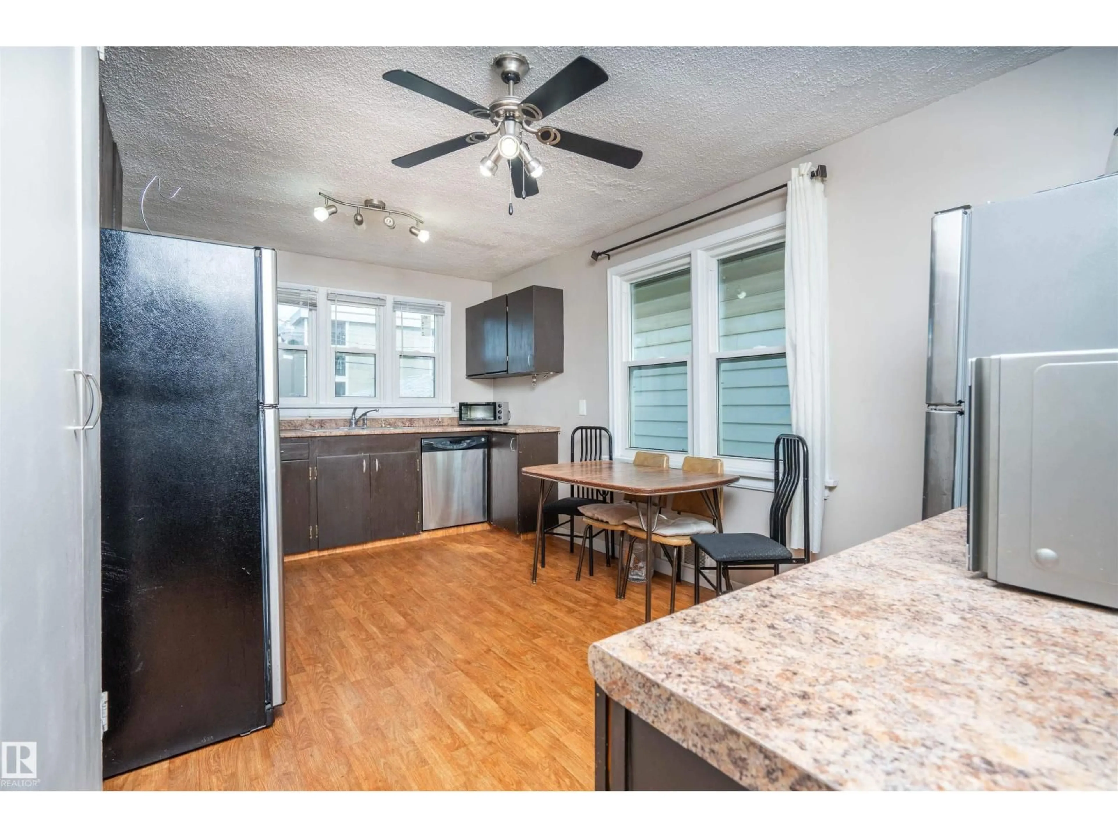 Open concept kitchen, wood/laminate floor for 12919 66 ST, Edmonton Alberta T5C0A6