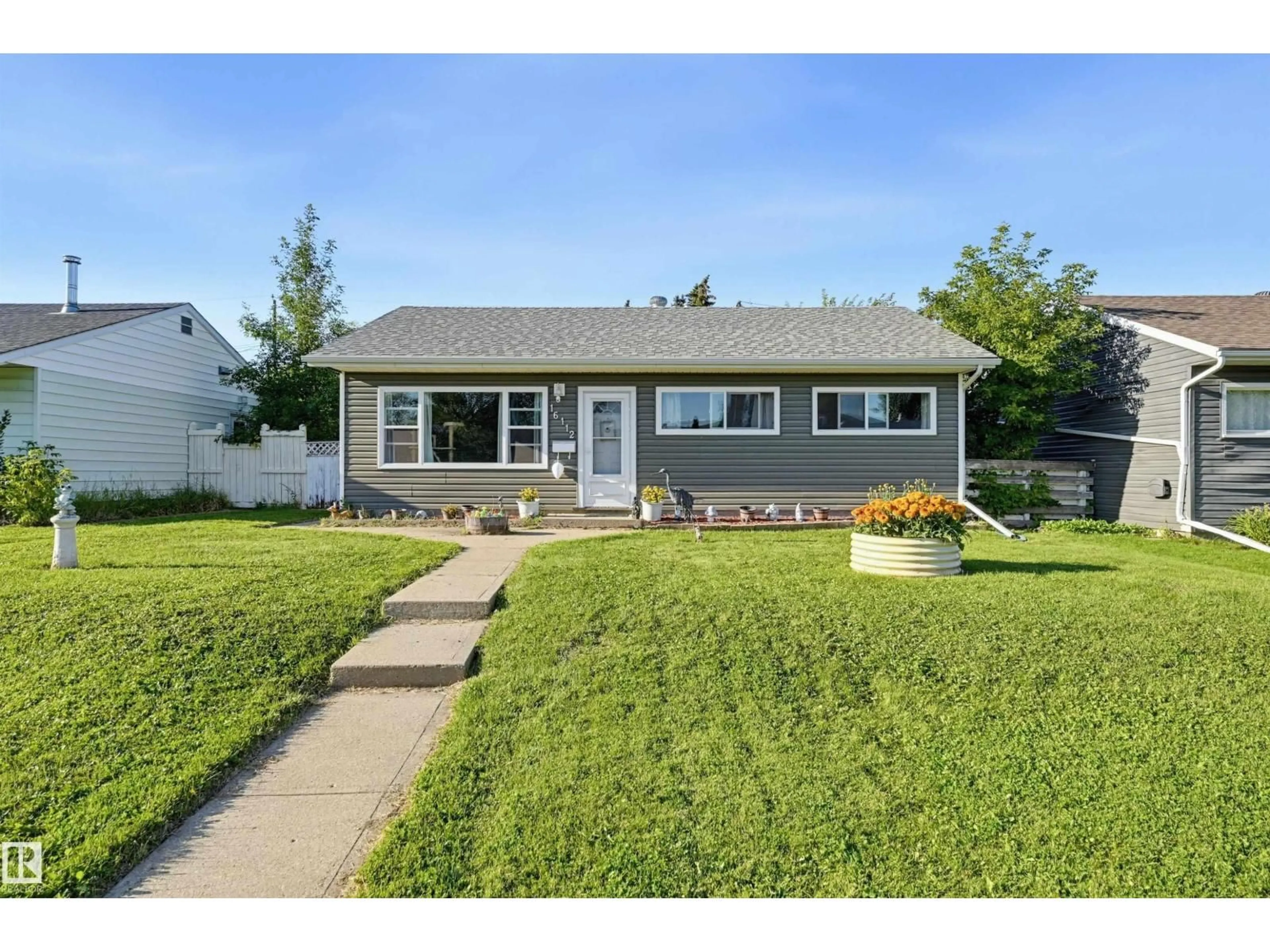 Home with vinyl exterior material, street for NW - 16112 108 AV, Edmonton Alberta T5P4E4