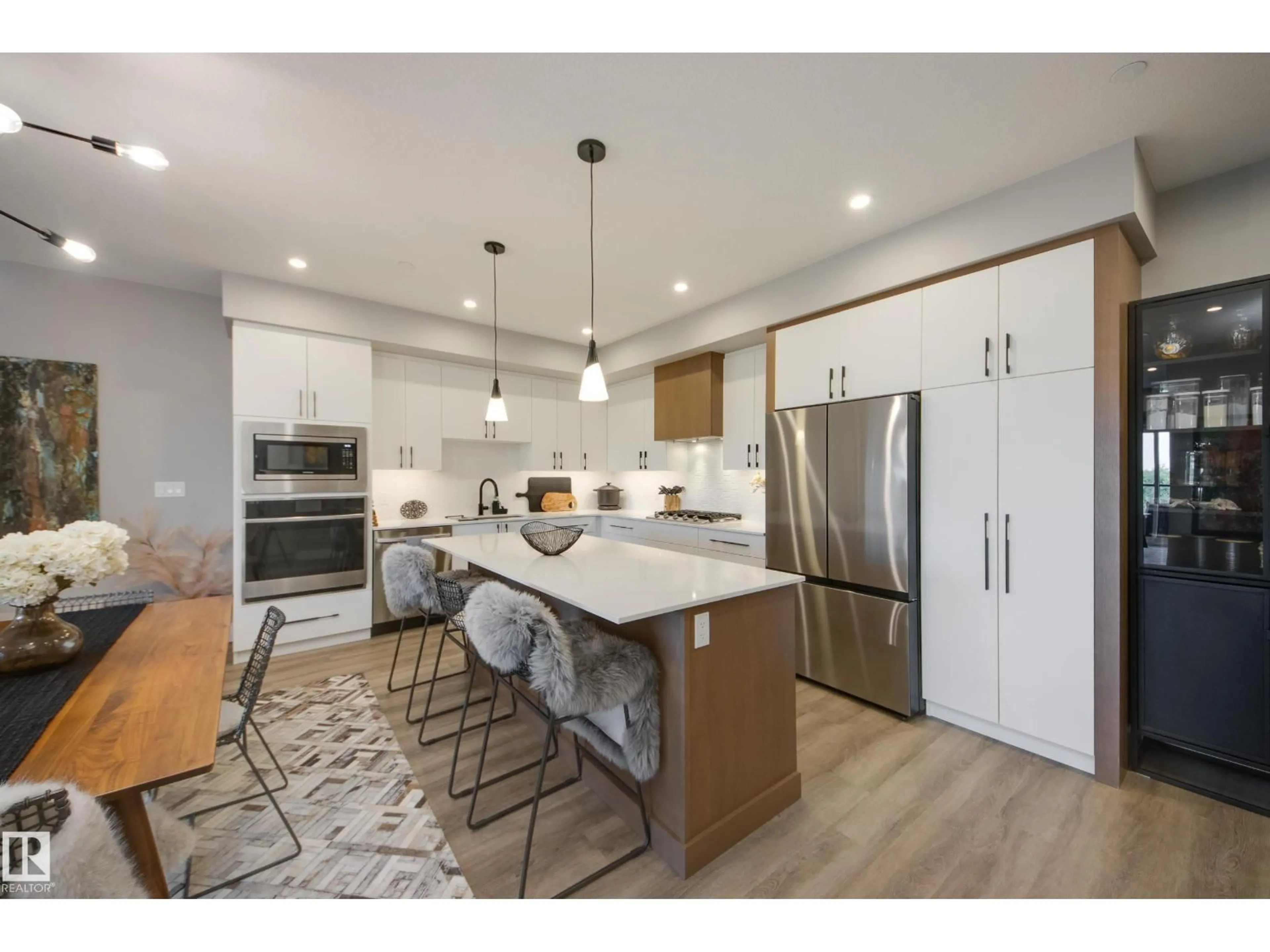 Open concept kitchen, wood/laminate floor for #312 - 7471 MAY CM, Edmonton Alberta T6X1E9