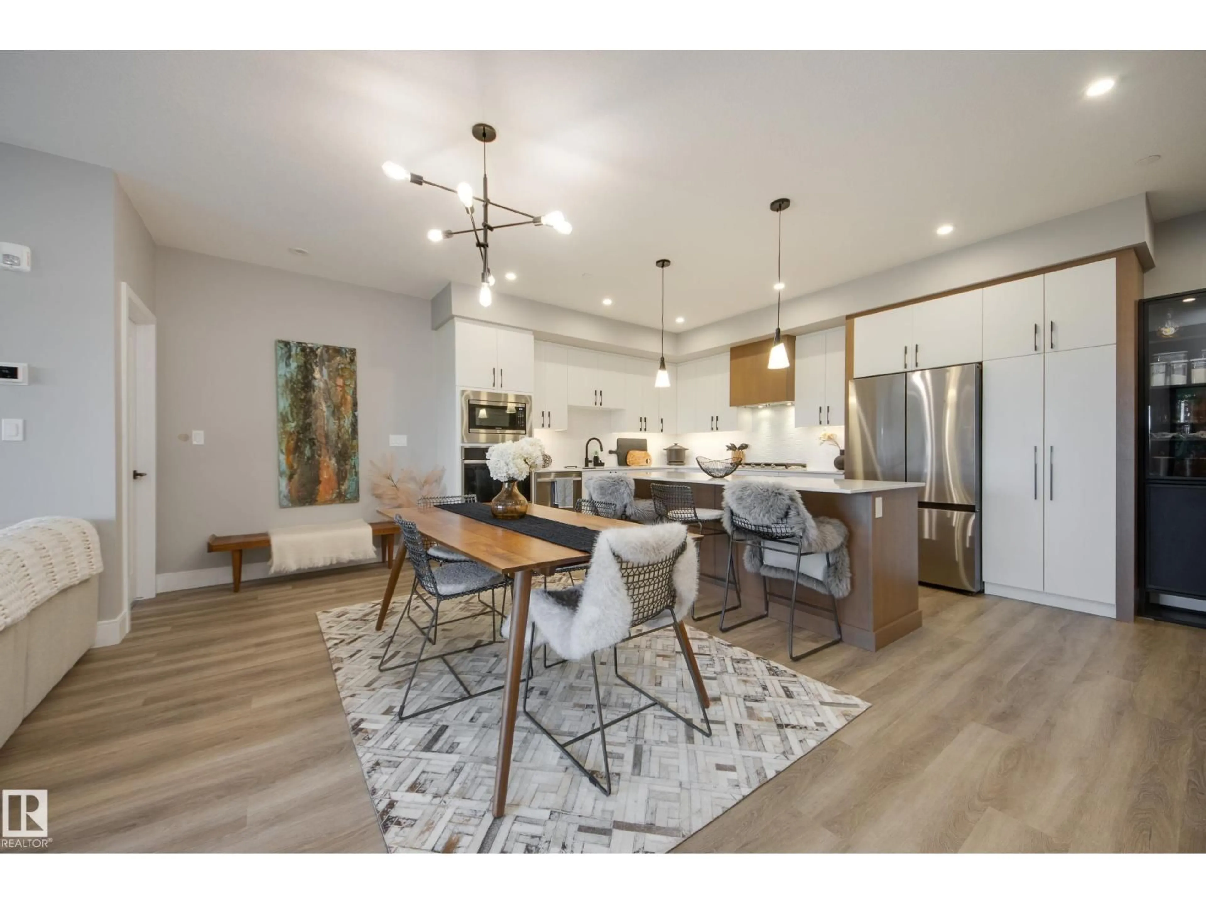 Open concept kitchen, wood/laminate floor for #312 - 7471 MAY CM, Edmonton Alberta T6X1E9