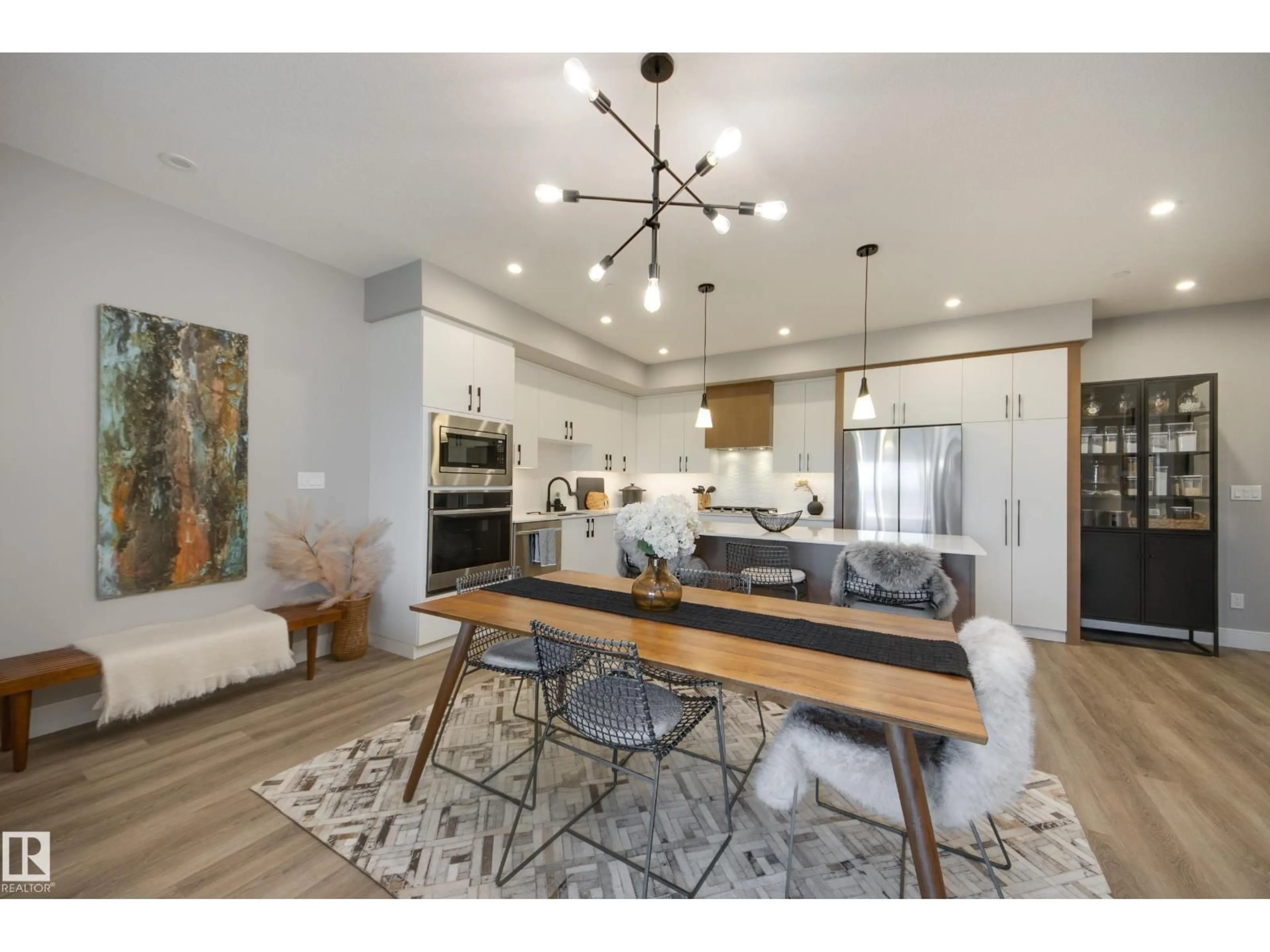 Open concept kitchen, wood/laminate floor for #312 - 7471 MAY CM, Edmonton Alberta T6X1E9