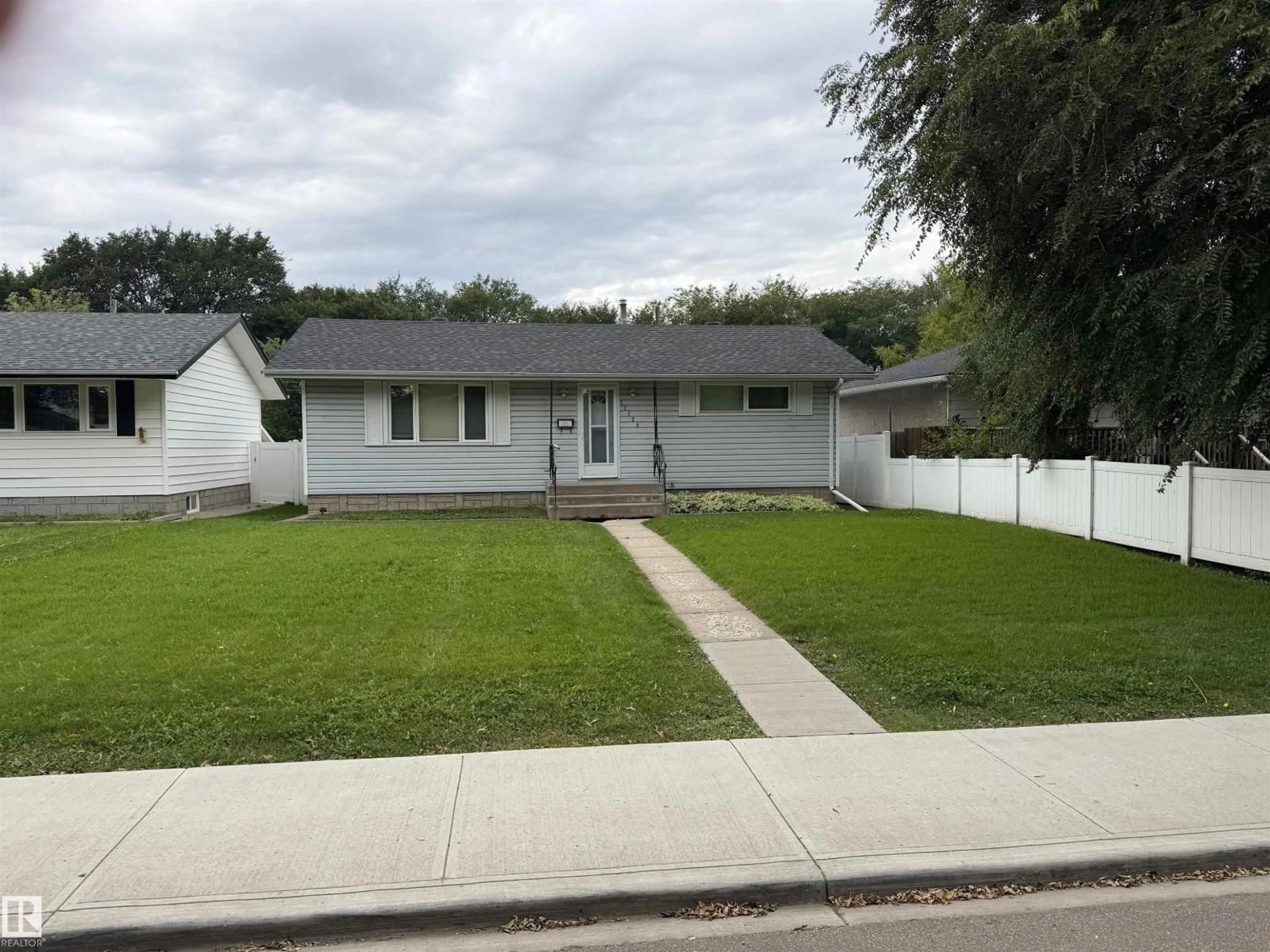 Home with vinyl exterior material, street for 12124 51 ST, Edmonton Alberta T5W3G9