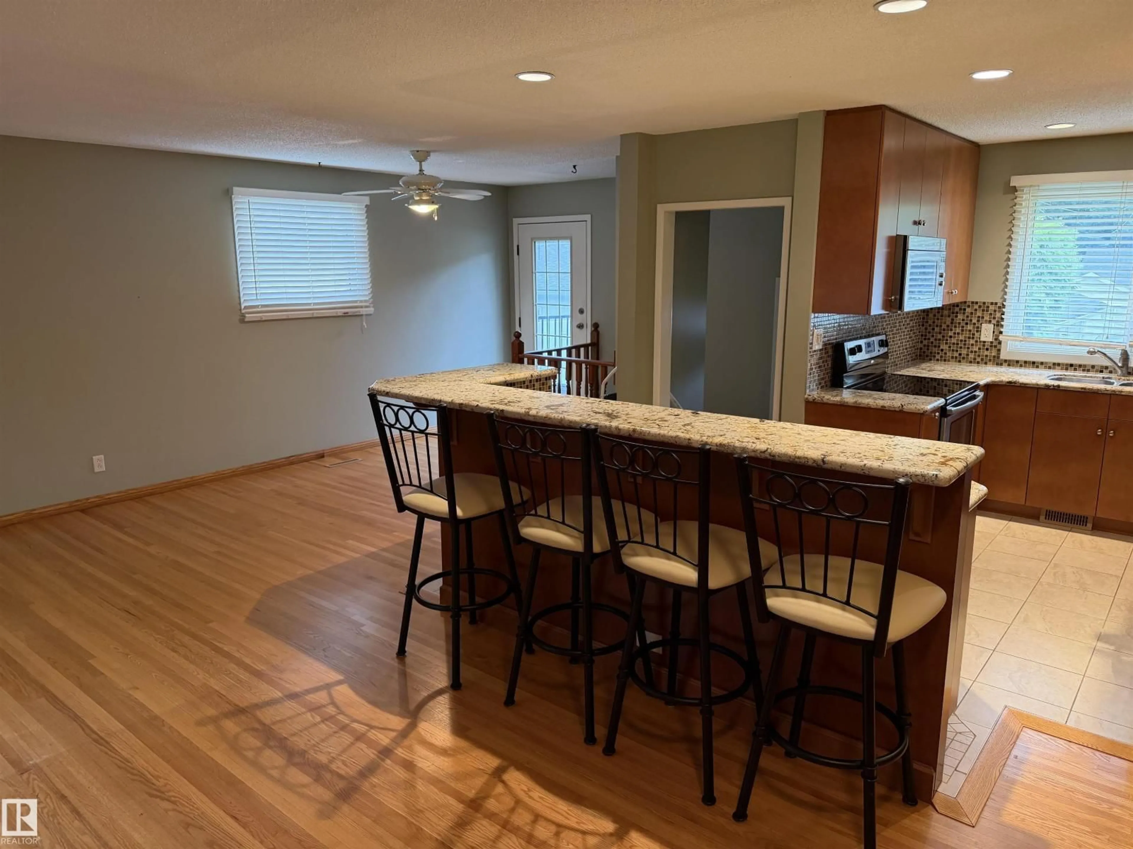 Open concept kitchen, wood/laminate floor for 12124 51 ST, Edmonton Alberta T5W3G9