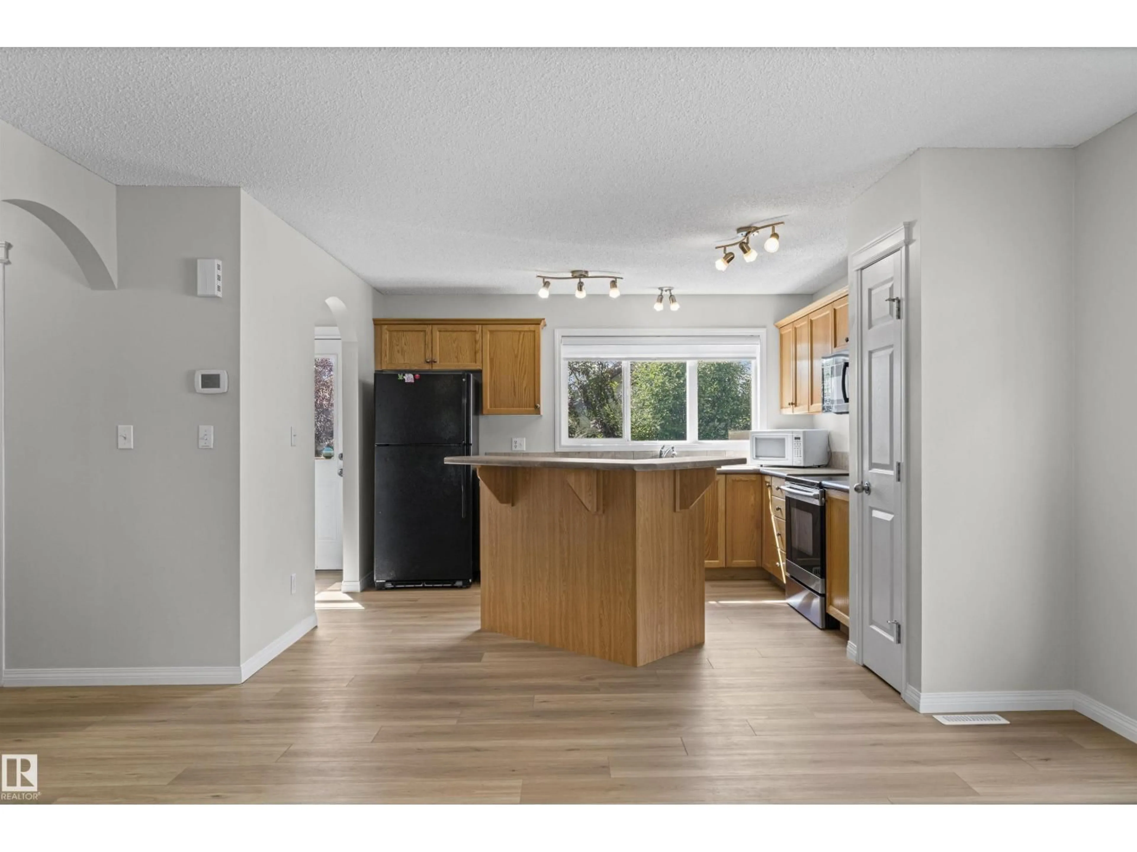 Open concept kitchen, wood/laminate floor for NW - 5509 STEVENS CR, Edmonton Alberta T6R3R4